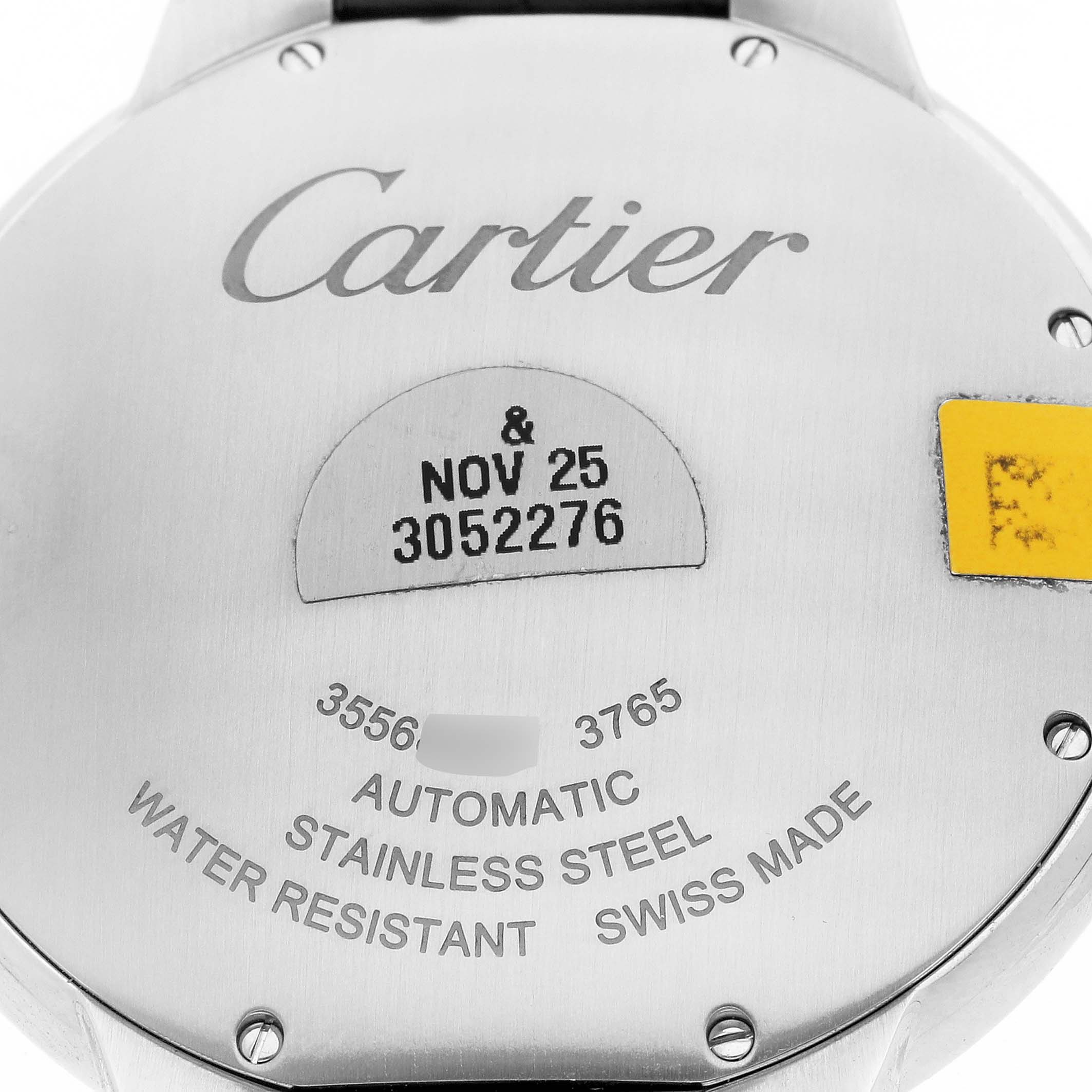 The image shows the back case of a Cartier Ballon Bleu WSBB0027 Men's Stainless Steel Blue Dial watch, featuring engraved details and text.