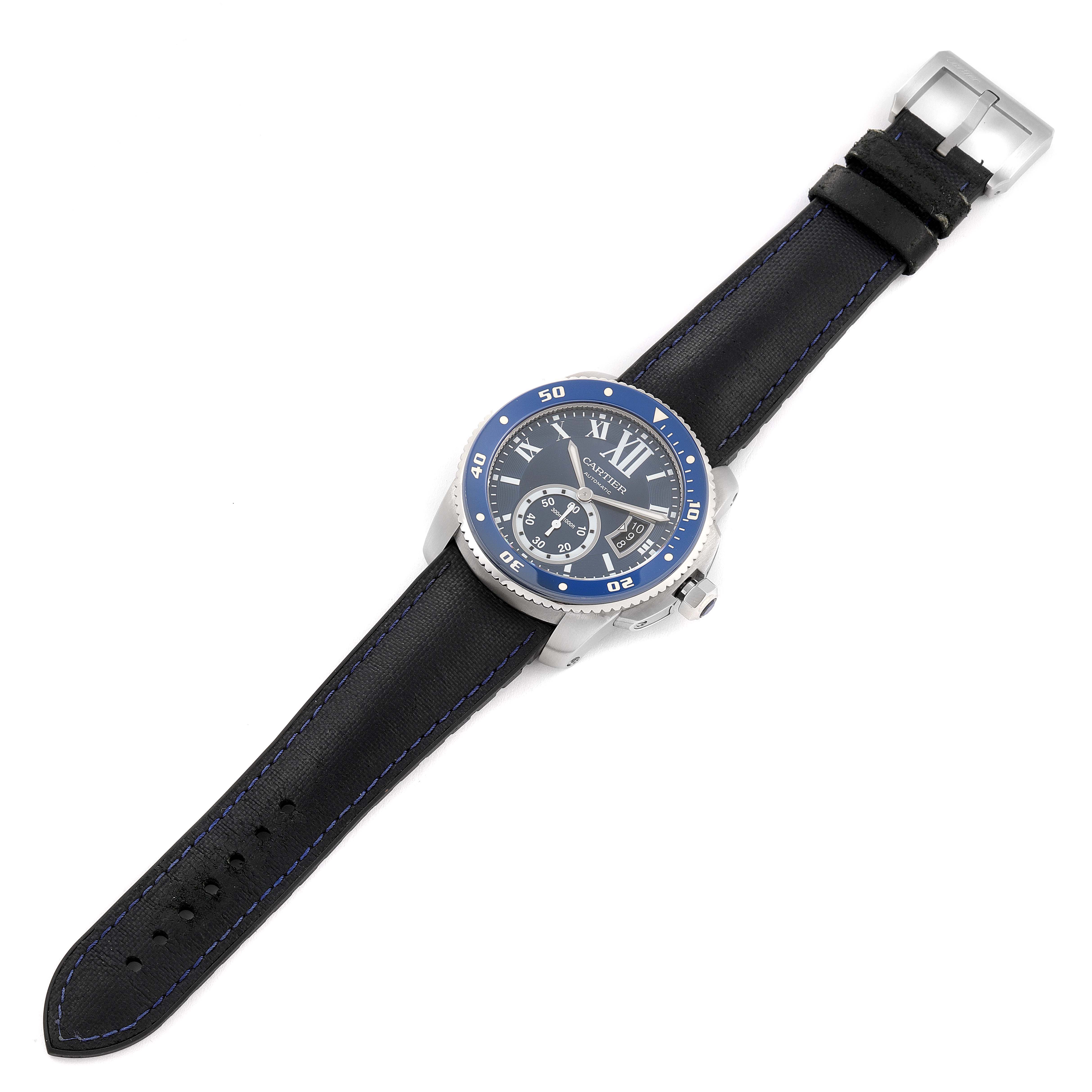 This image shows a top-down view of a Calibre de Cartier model watch by Cartier, featuring its face and leather strap.