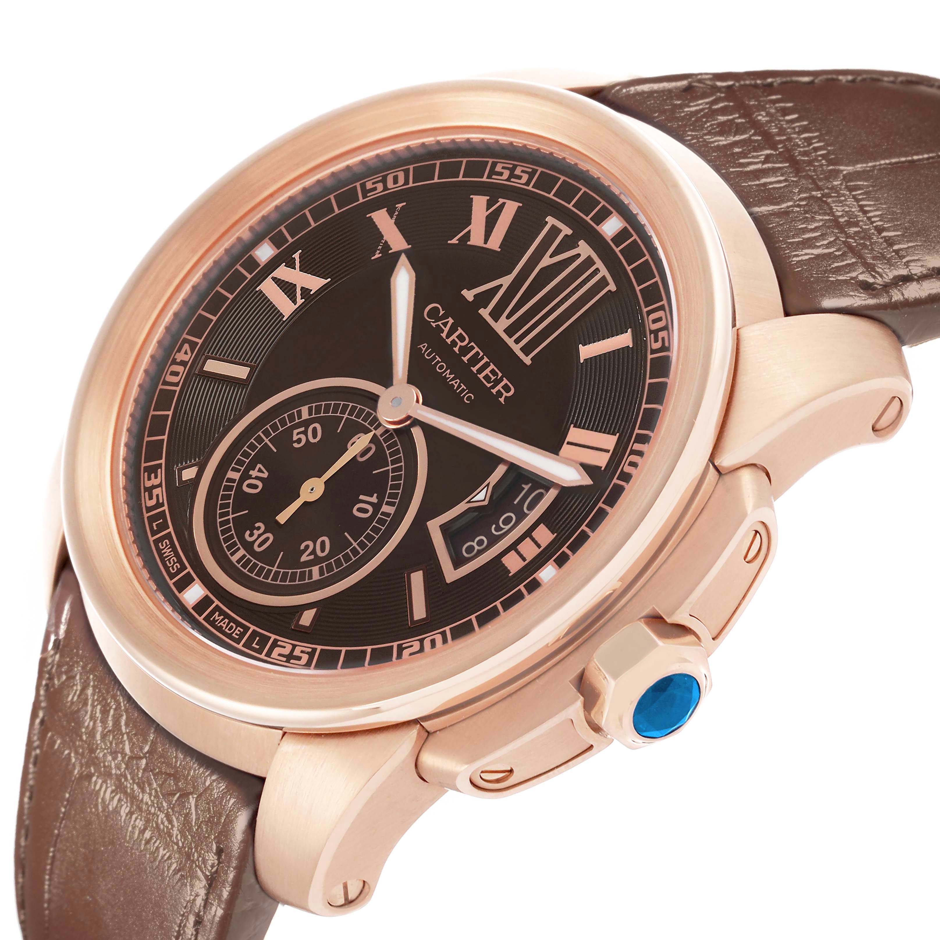 The Calibre de Cartier W7100007 men's watch is shown at an angled side view highlighting its face, bezel, crown with a blue gem, and part of the leather strap.