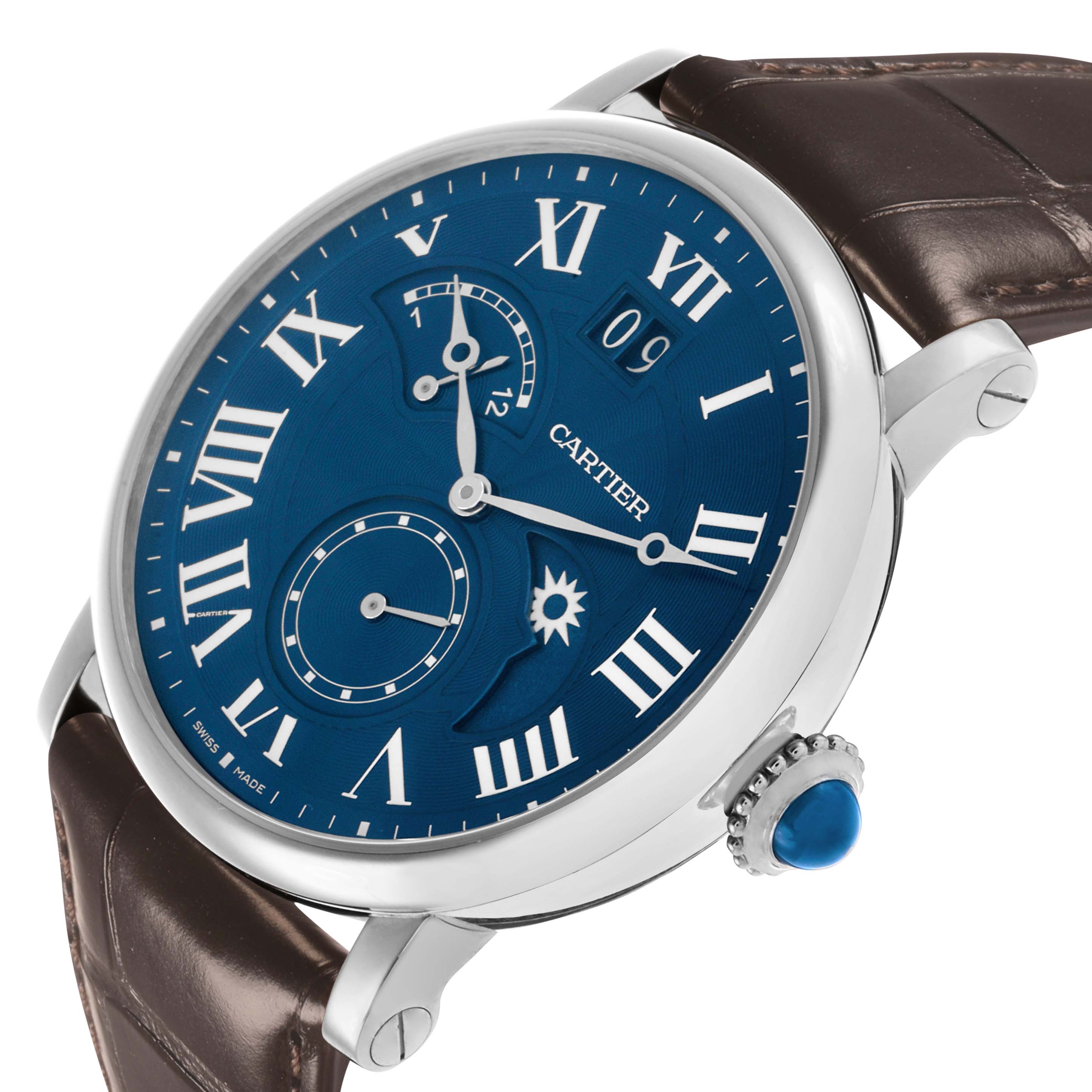 The Rotonde by Cartier is shown at a slight angle displaying the blue dial, Roman numerals, subdials, and the crown with a blue cabochon.