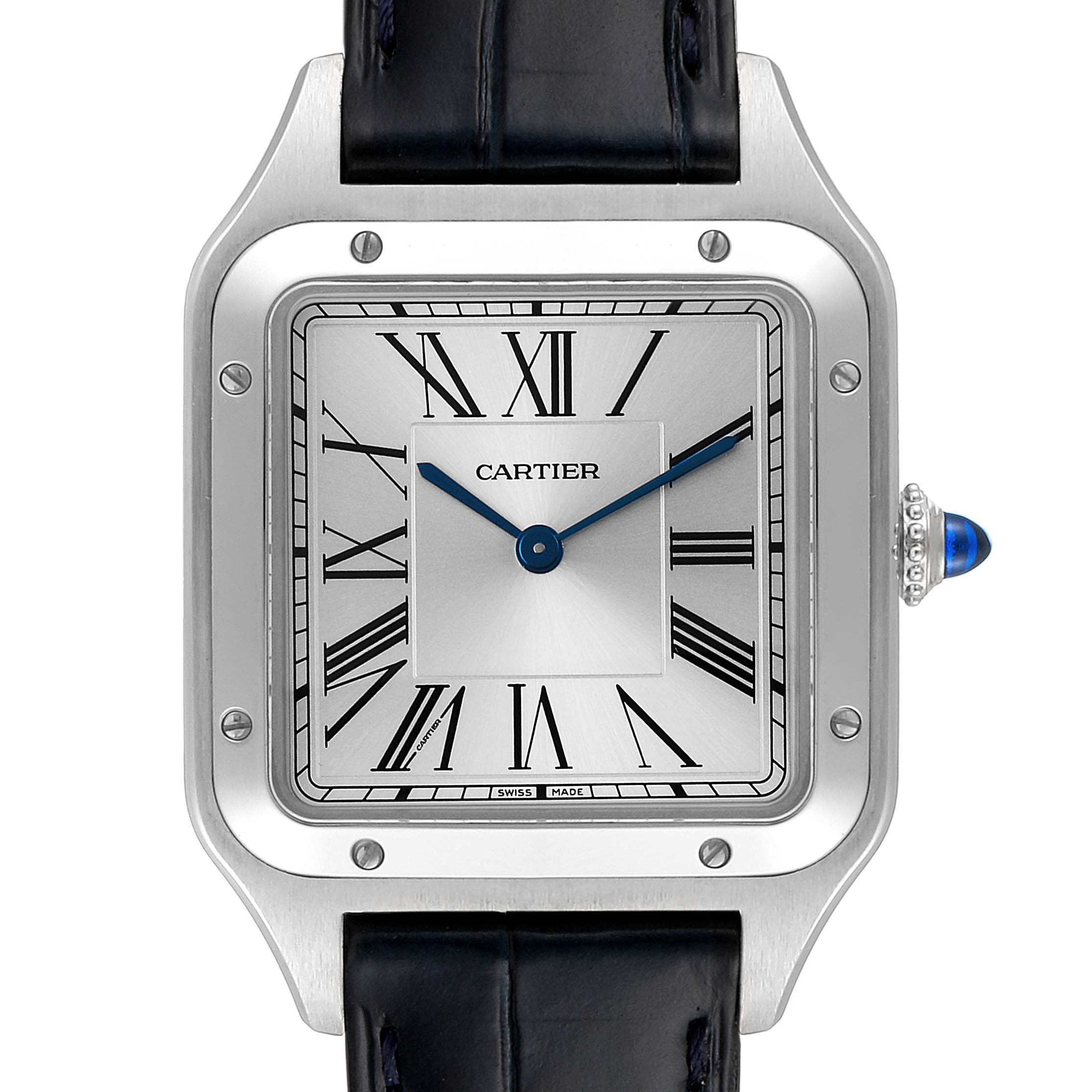 The image shows a front view of the Cartier Santos Dumont WSSA0022 Men's Stainless Steel Silver Dial WSSA0022 Men's Stainless Steel Silver Dial model watch, featuring its square face with Roman numerals and a blue cabochon on the crown.