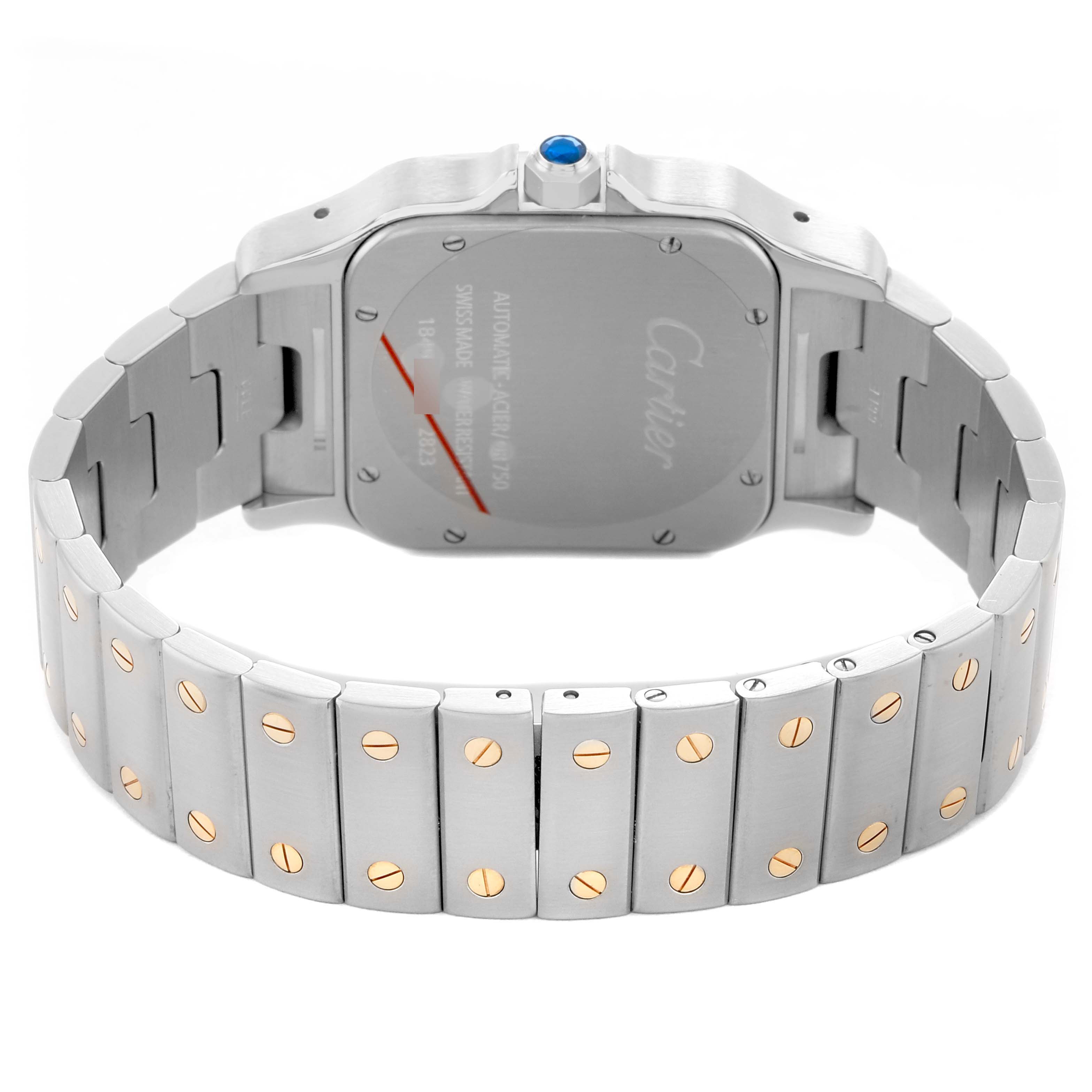 The Cartier Santos W20099C4 Men's Stainless Steel Silver Dial watch is shown from the back, displaying its bracelet and case back with visible screws and a blue cabochon crown.