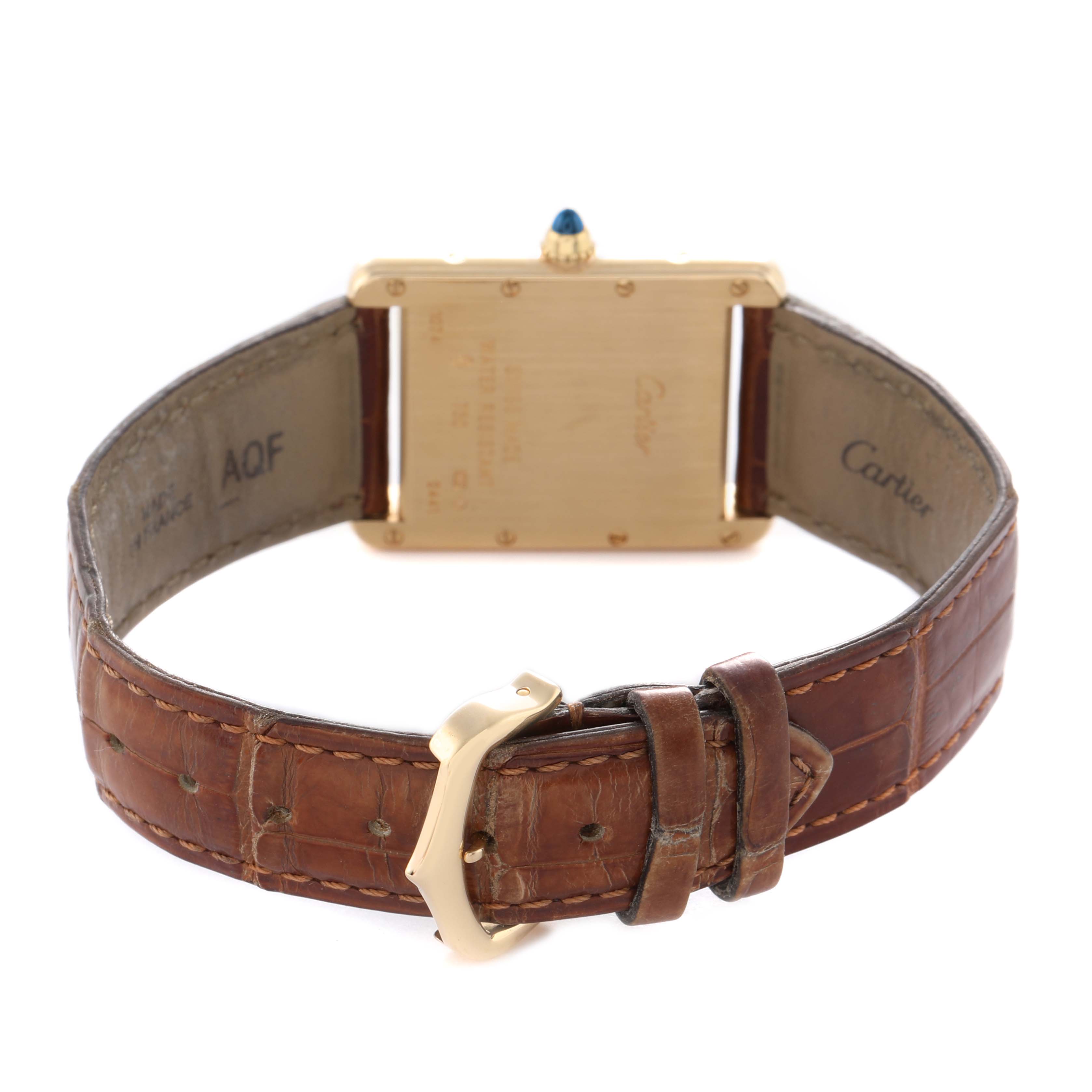 The image shows the back of the Cartier Tank Louis W1529756 Men's Yellow Gold Silver Dial watch with a brown leather strap and buckle.