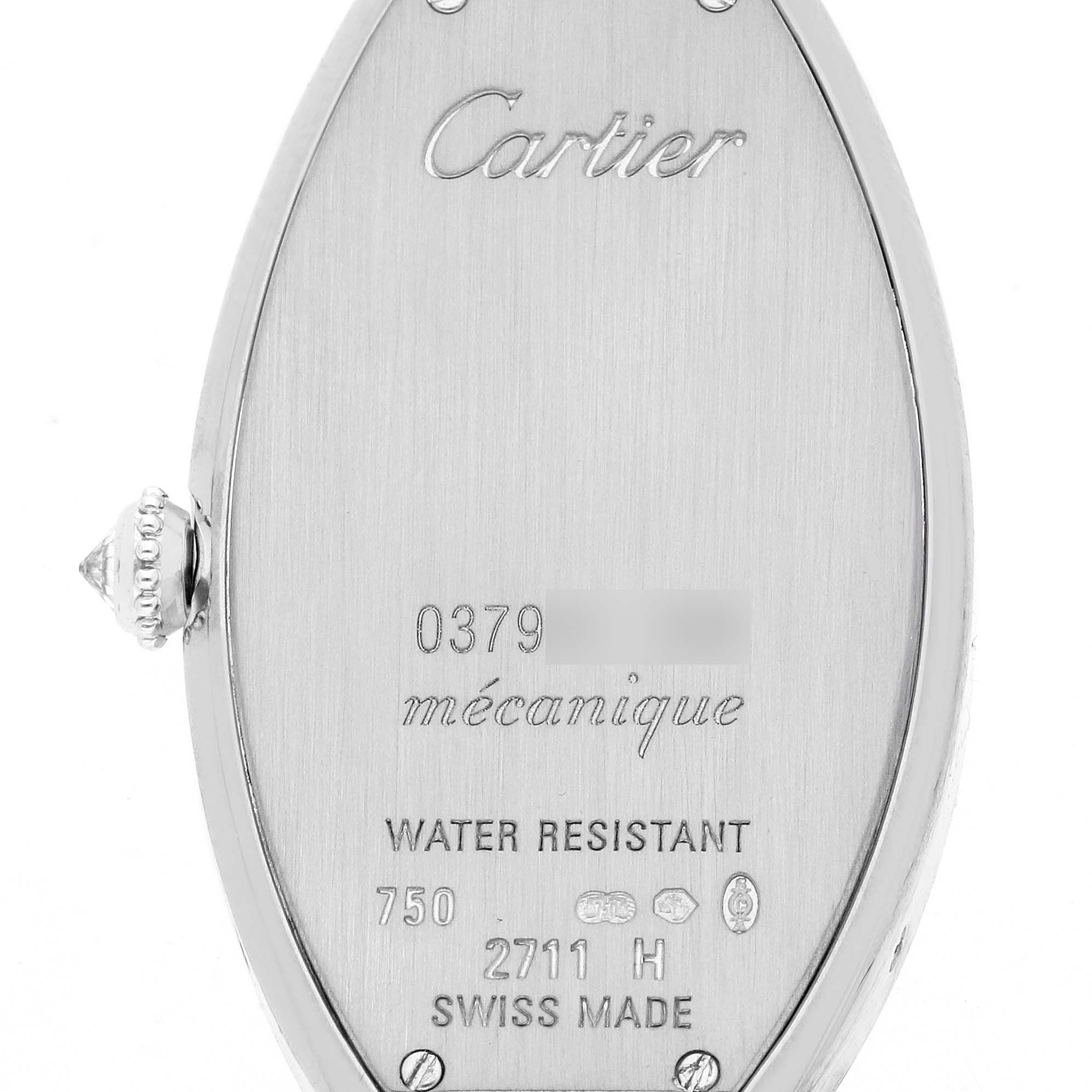 The image shows the back of a Cartier Tonneau WE400131 Women's White Gold Silver Dial watch, featuring engravings and a side view of the crown.