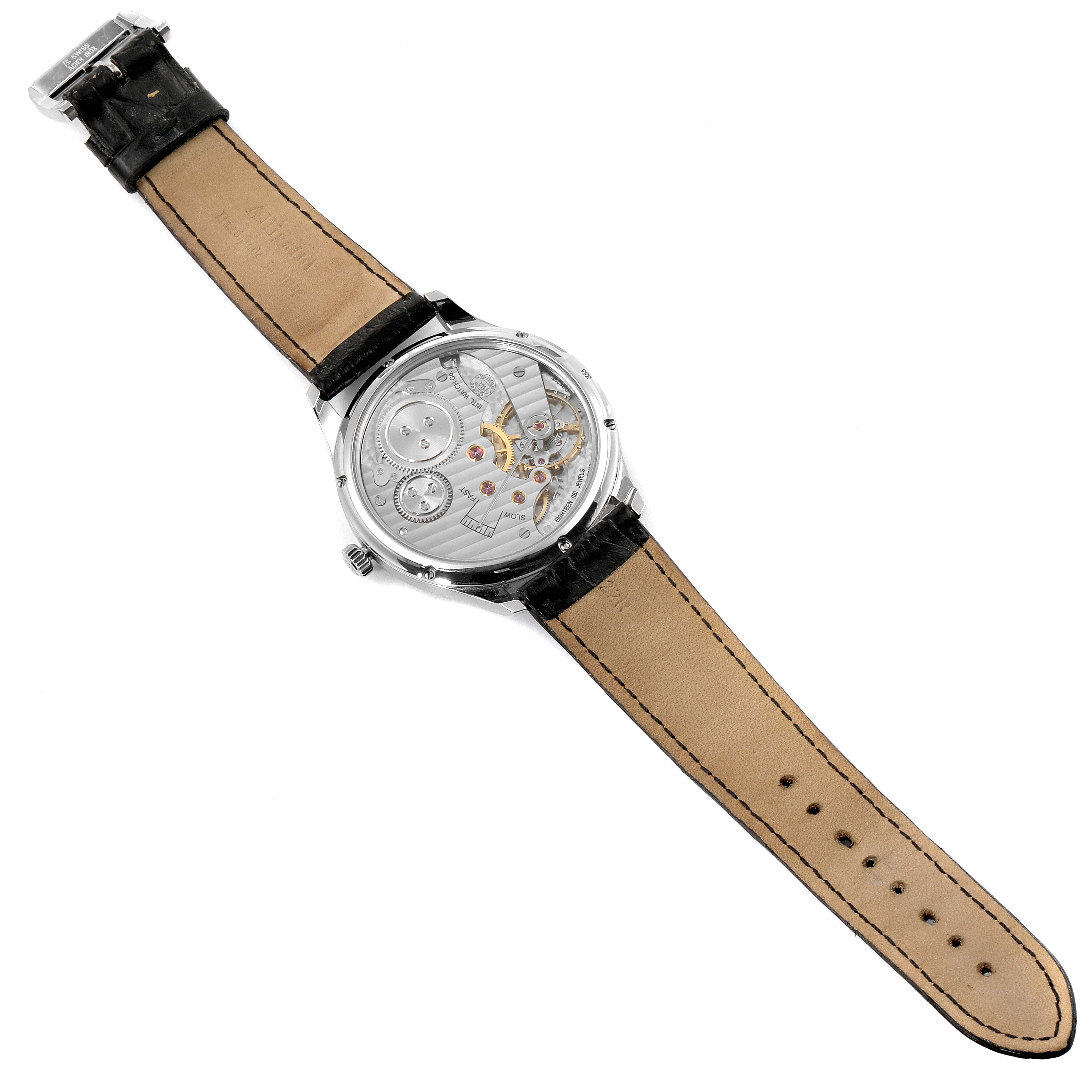 The image shows the back view of an IWC Portuguese IW545405 Men's Stainless Steel Silver Dial IW545405 Men's Stainless Steel Silver Dial model watch, highlighting its intricate mechanical movement and leather strap.