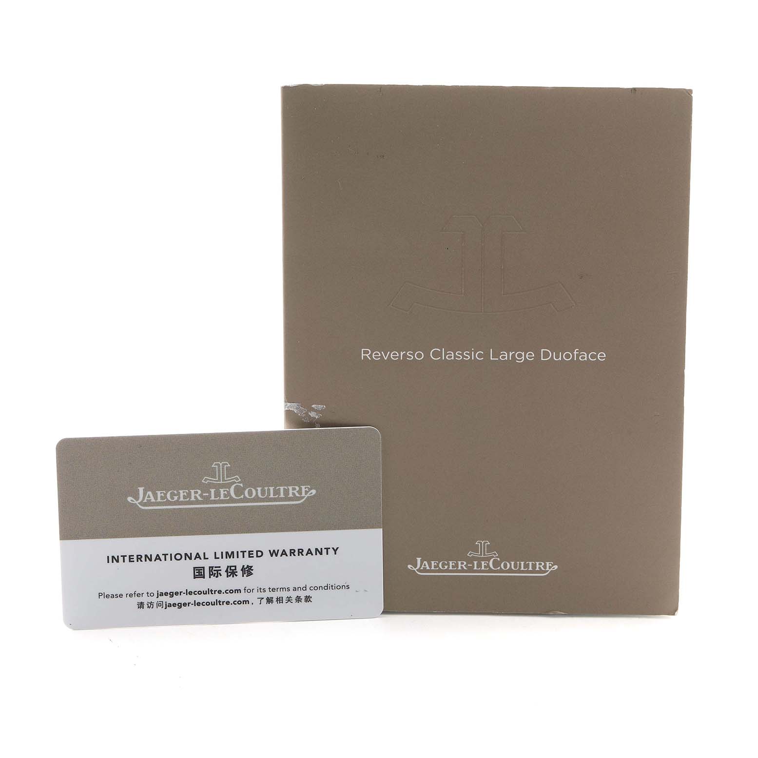 The image shows the warranty card and booklet for a Jaeger-LeCoultre Reverso Classic Large Duoface.