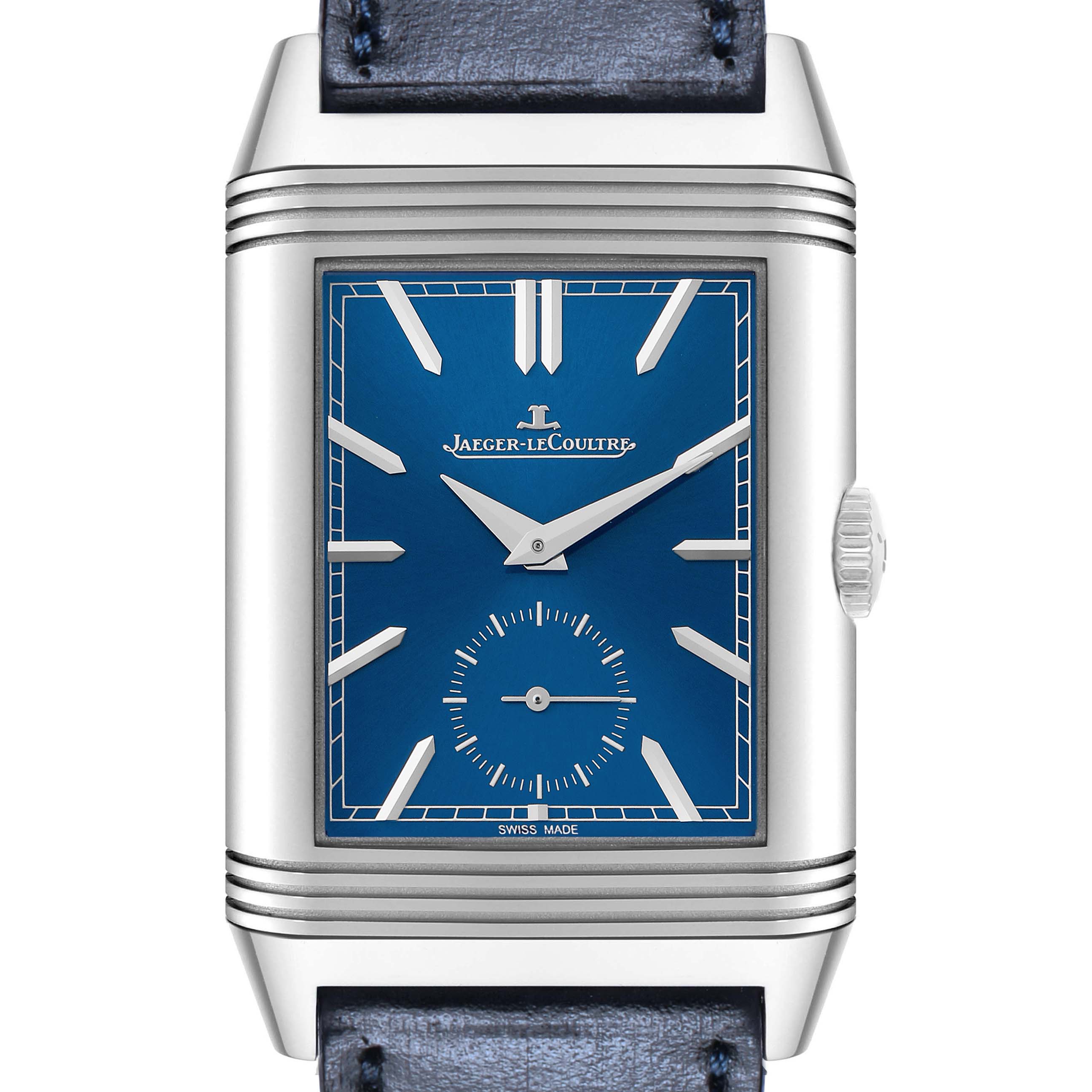 The Jaeger-LeCoultre Reverso watch is shown from a front angle, highlighting the blue dial, crown, and partial strap.