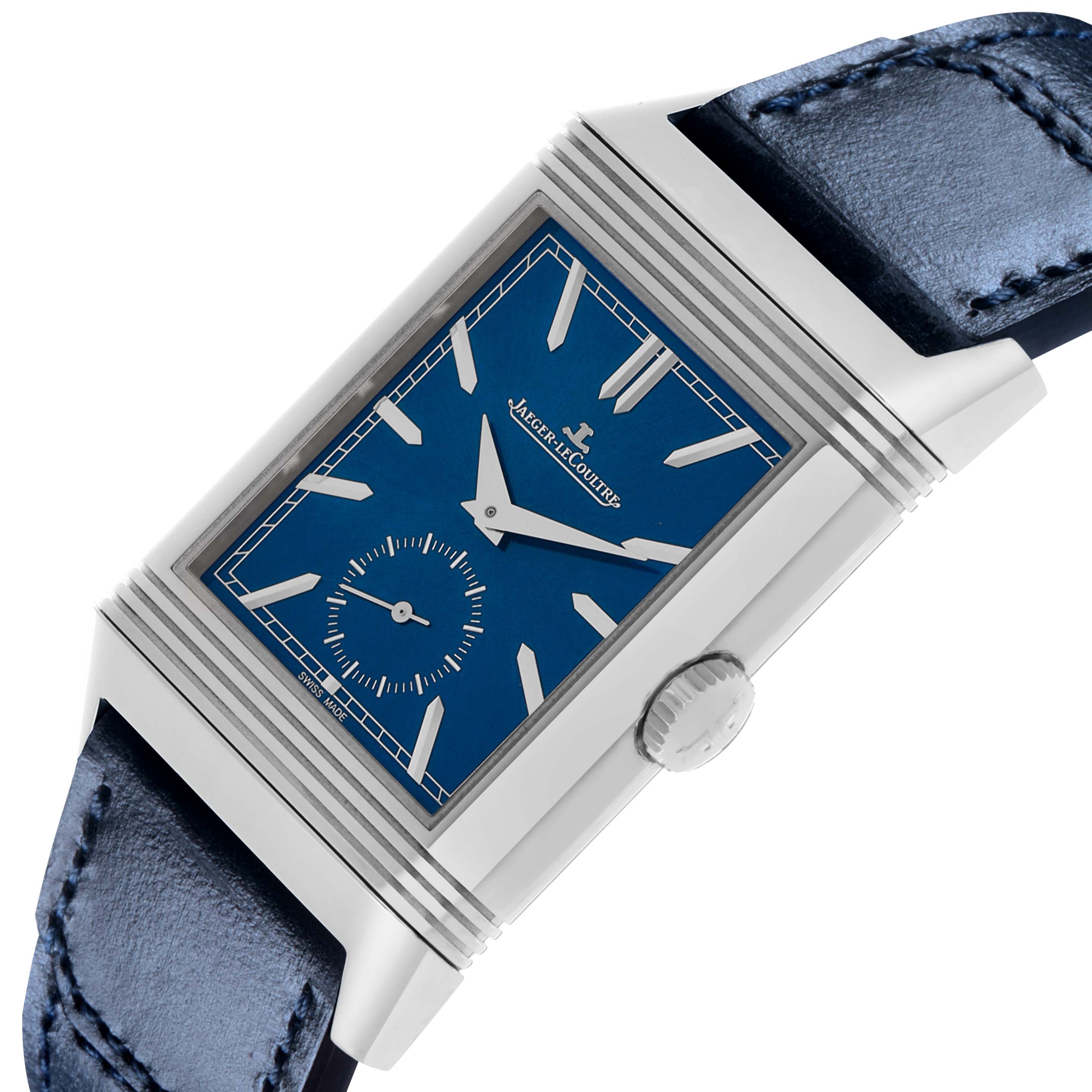 The Jaeger LeCoultre Reverso Q3988482/215.8.D4 Men's Stainless Steel Blue Dial watch is shown at an angle highlighting the blue dial, case, crown, and leather strap.