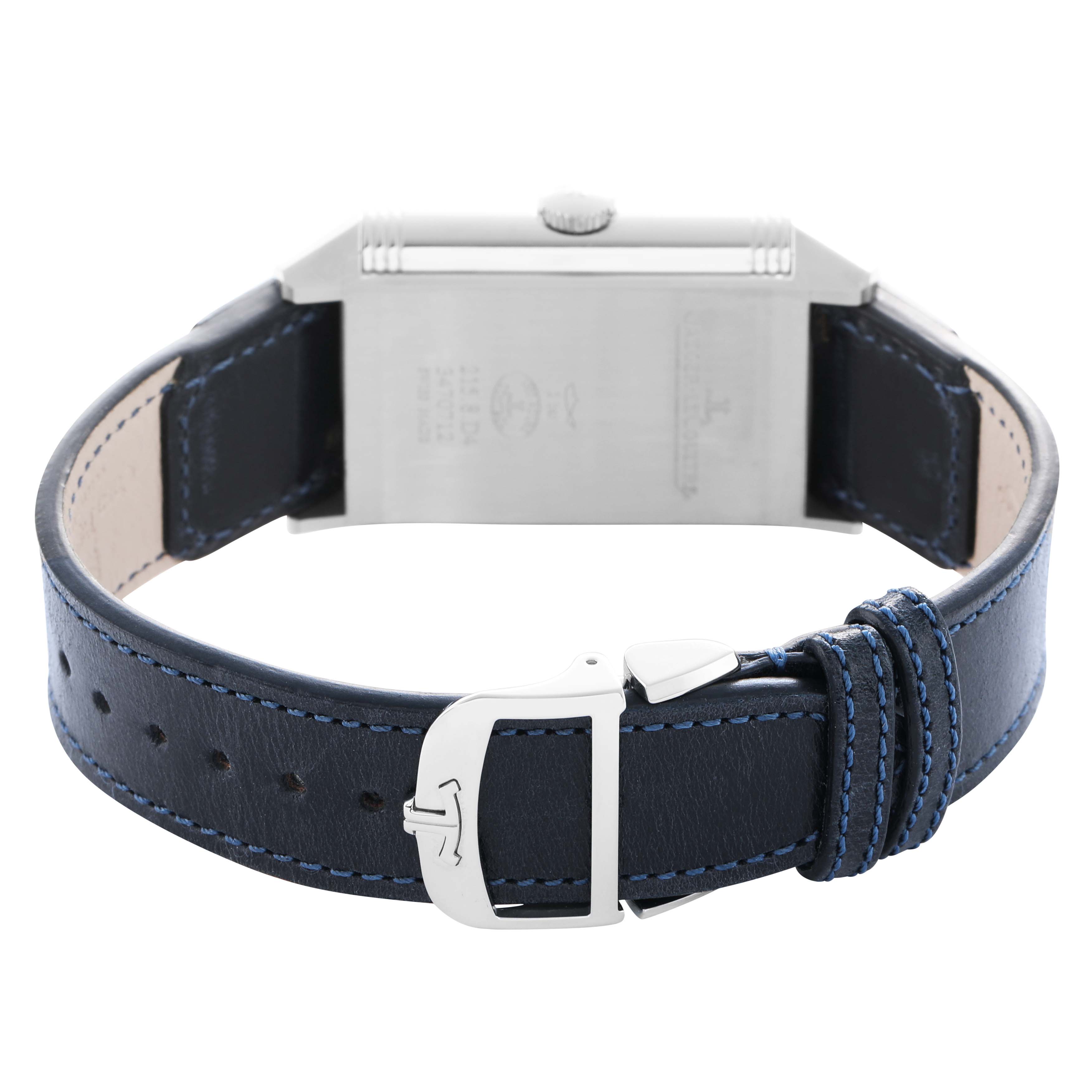 The Jaeger-LeCoultre Reverso watch is shown from the back, highlighting its case, crown, and blue leather strap with a buckle.