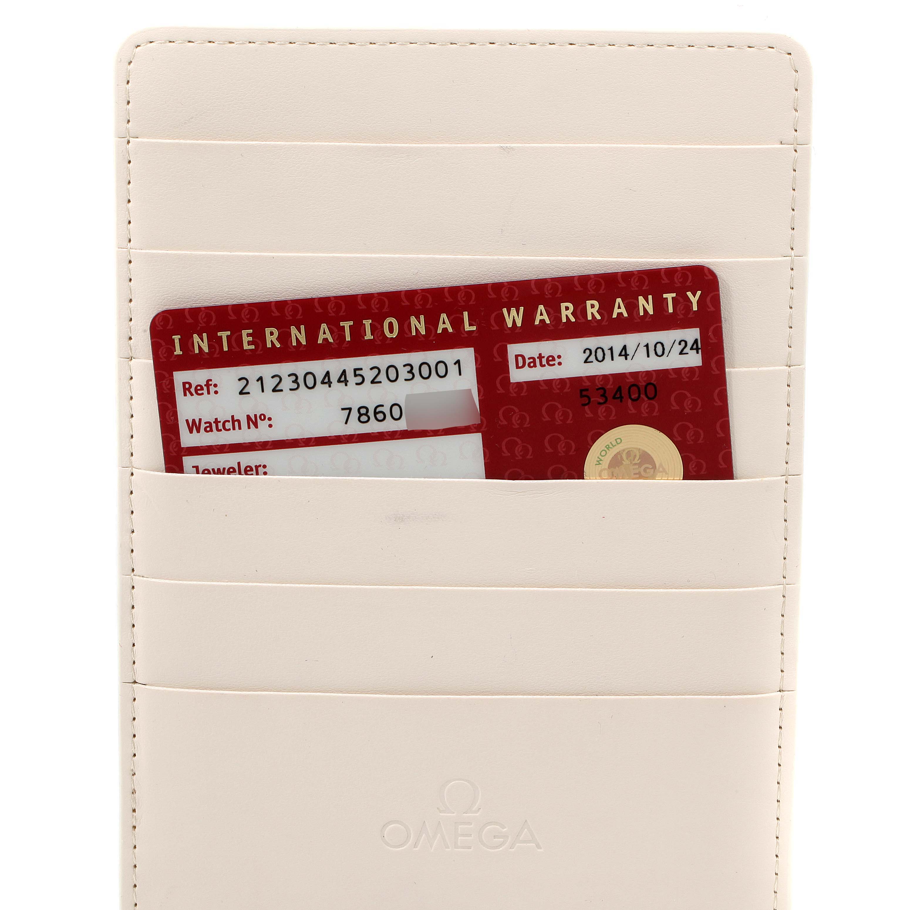 The image shows an Omega International Warranty card for the Seamaster model, placed inside a white Omega-branded wallet.