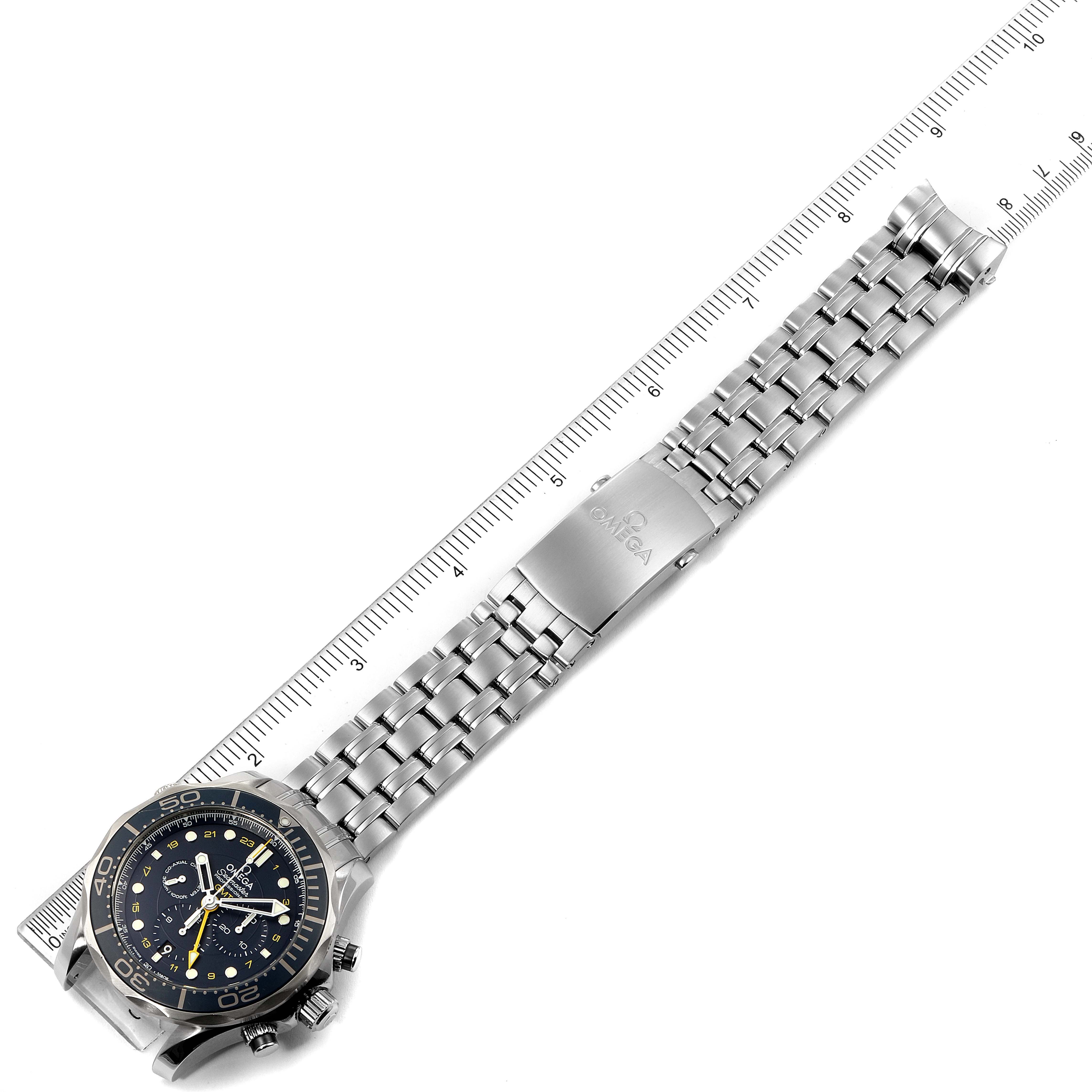 The image shows a top view of an Omega Seamaster 212.30.44.52.03.001  Men
s Stainless Steel Blue Dial 212.30.44.52.03.001  Men
s Stainless Steel Blue Dial watch with a metal bracelet and a measuring ruler placed beside it.