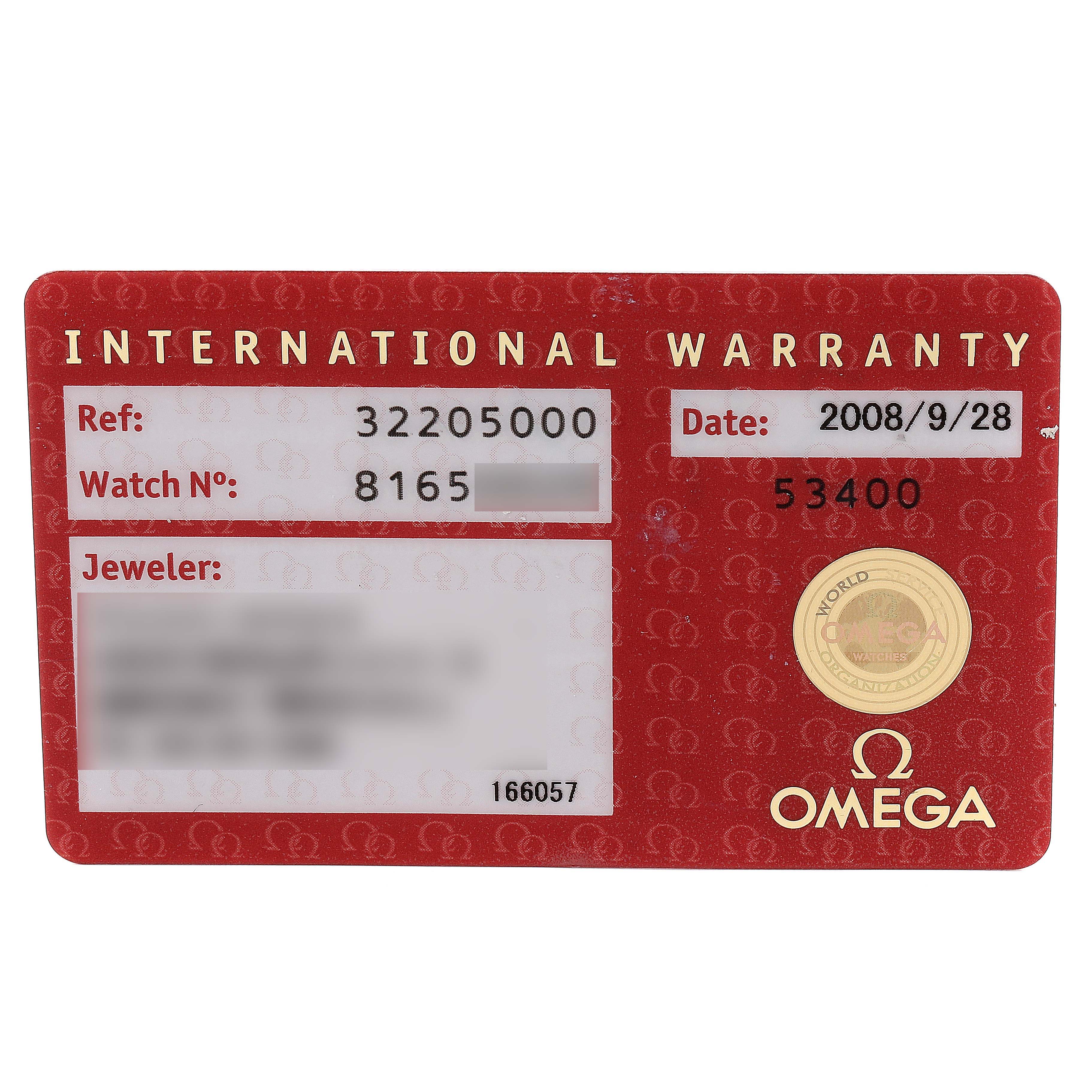 The image shows an OMEGA international warranty card for the Speedmaster model from a top-down angle.