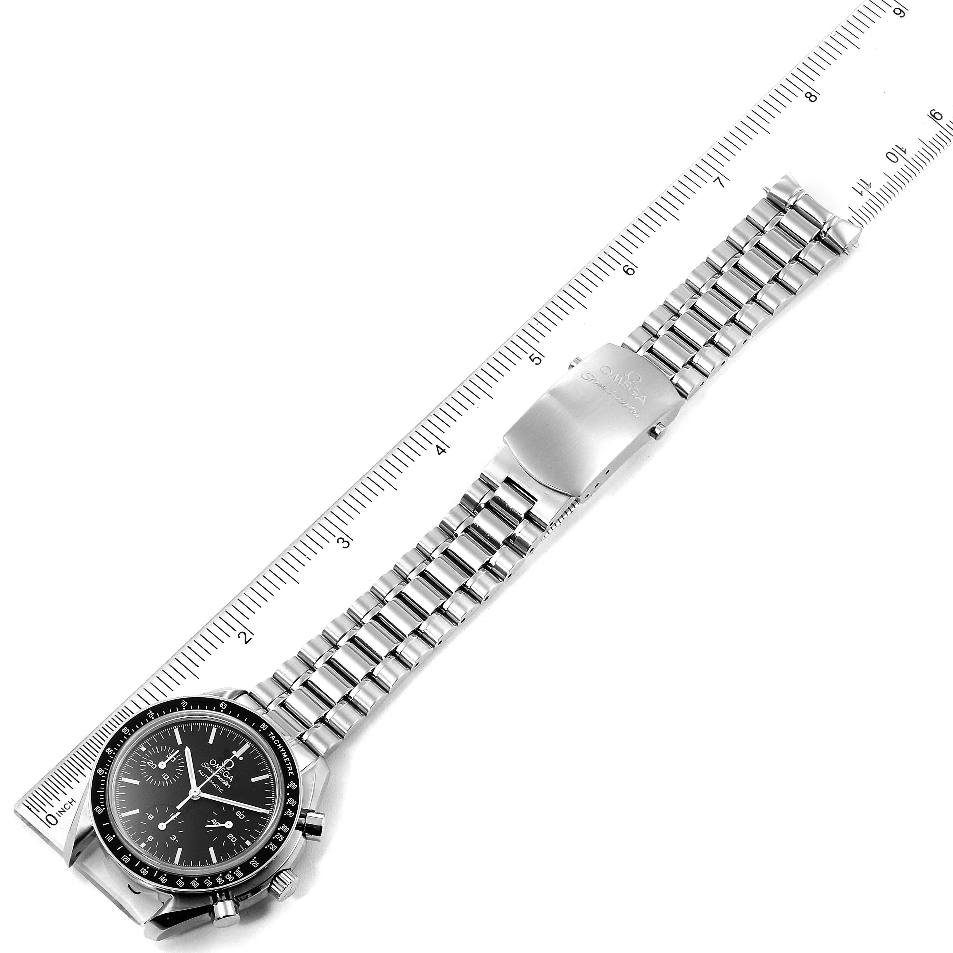 The image shows a top-down view of an Omega Speedmaster 3539.50.00 Men
s Stainless Steel Black Dial 3539.50.00 Men
s Stainless Steel Black Dial watch, highlighting the face, stainless steel bracelet, and clasp, alongside a ruler.