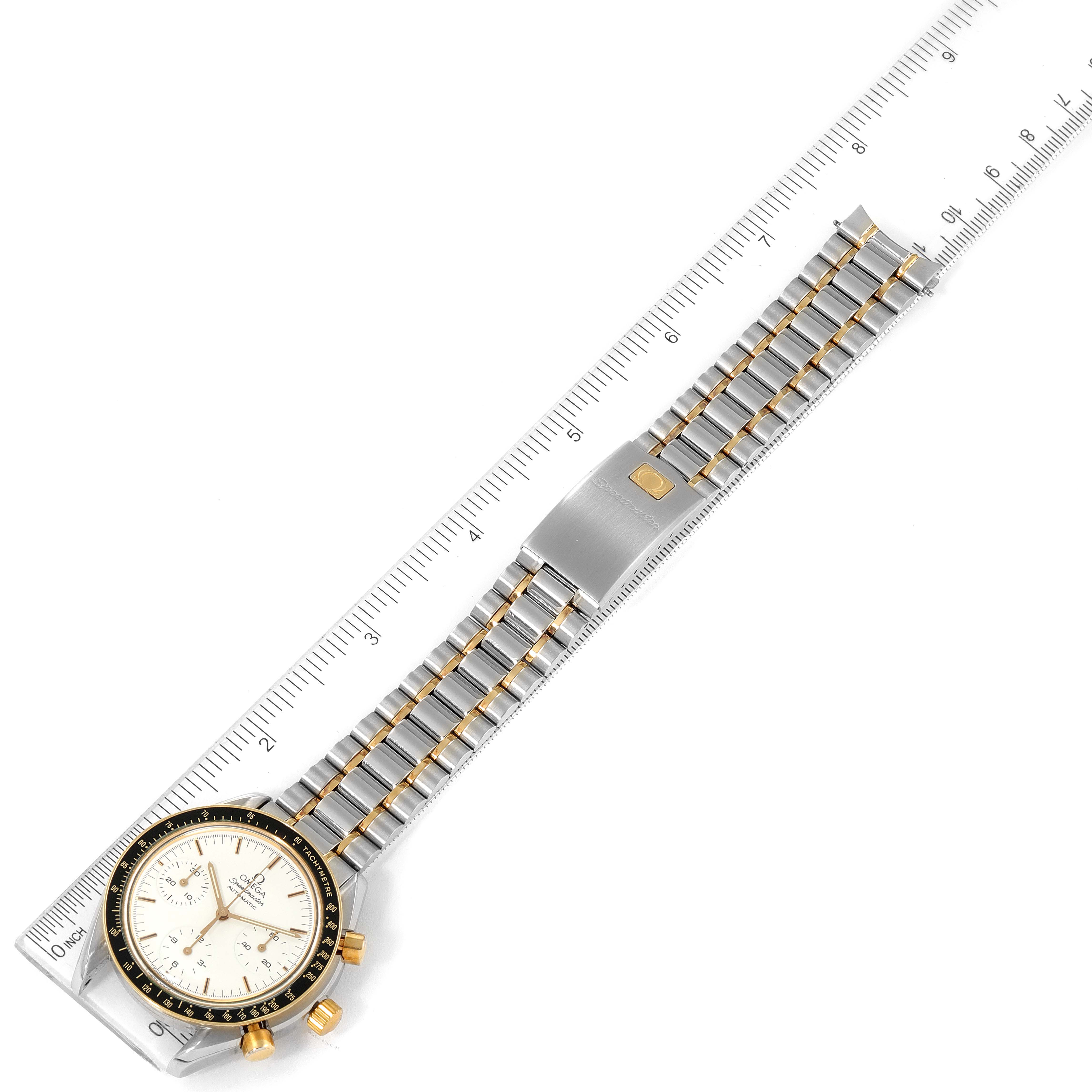 The image shows an Omega Speedmaster 3310.20.00 Men's Steel and Gold (two tone) White Dial 3310.20.00 Men's Steel and Gold (two tone) White Dial watch laid flat, displaying the full bracelet and a part of the dial, measured with a ruler.