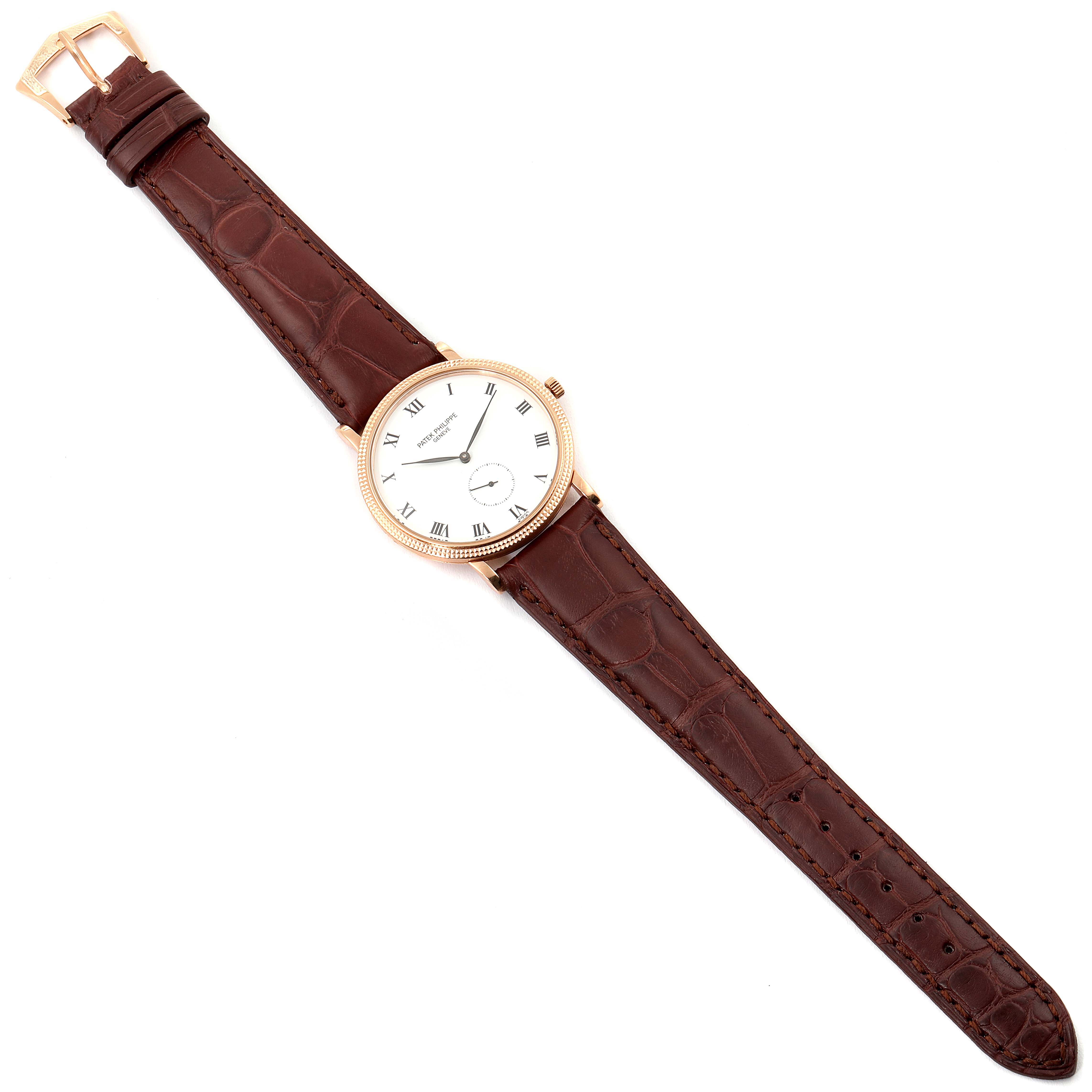 This image displays a Patek Philippe Calatrava 3919R Men
s Rose Gold White Dial 3919R Men
s Rose Gold White Dial watch in a top-down view, showing the face, strap, and buckle.