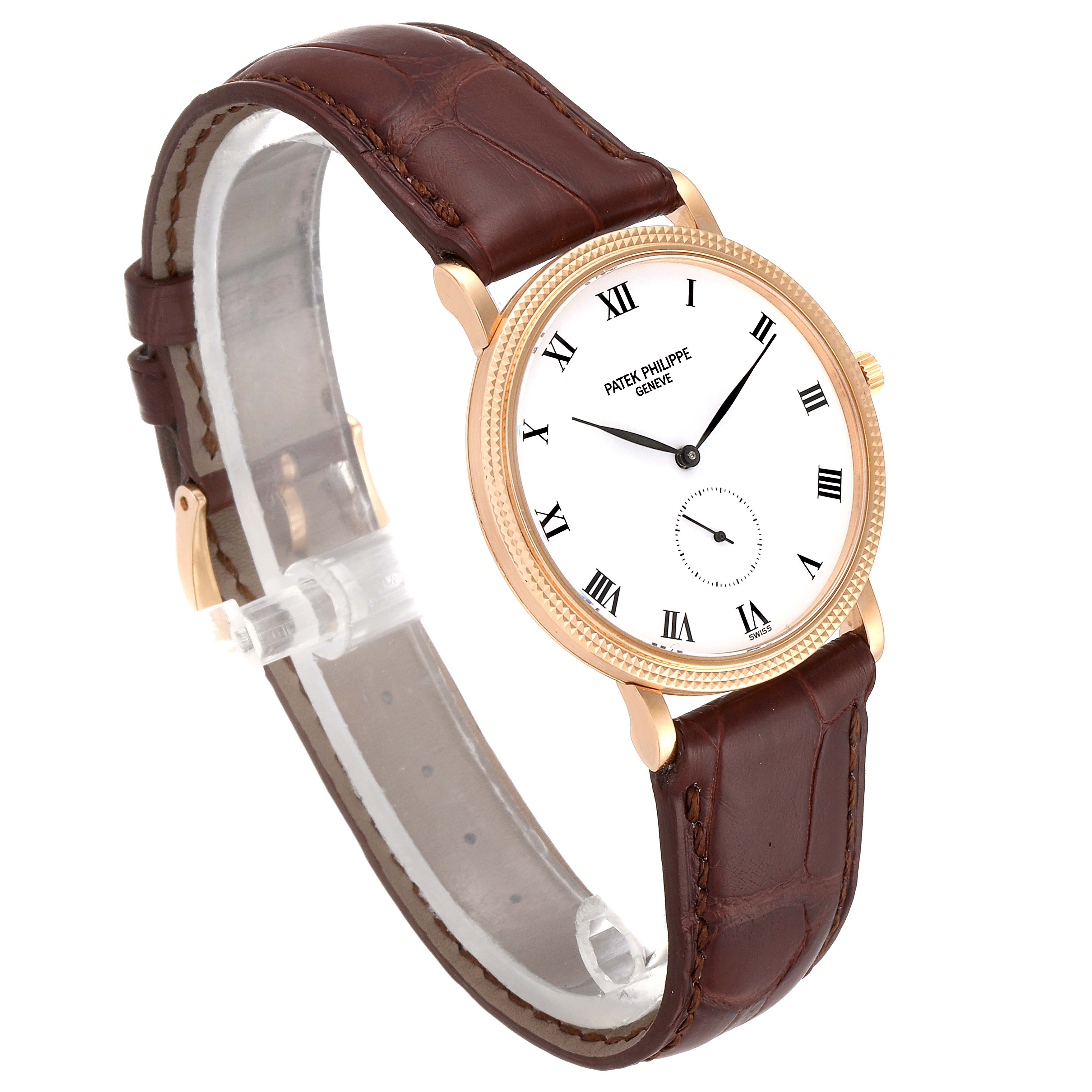 This image shows a Calatrava model by Patek Philippe from a front-left angle, featuring a brown leather strap and white dial with Roman numerals.