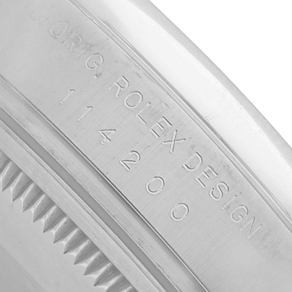 The image shows a close-up of the Rolex Air-King 114200 Men's Stainless Steel Pink Dial's case side with engraved details.