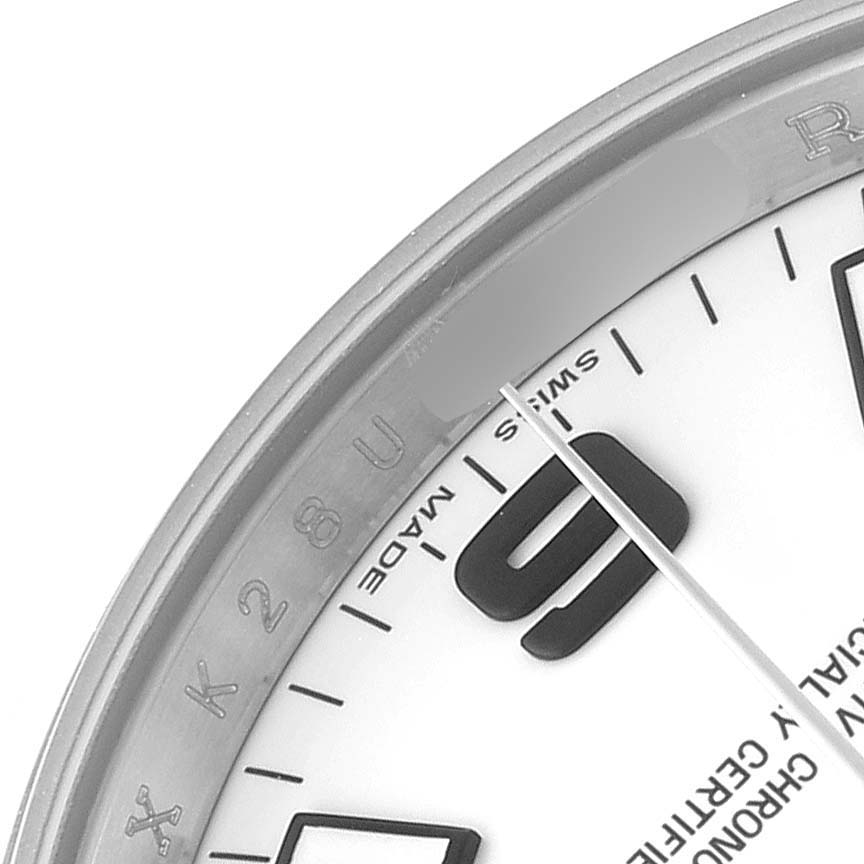 The image shows a partial view of the Rolex Air-King 114200 Men's Stainless Steel White Dial watch, displaying part of the dial, numeral, and flange with engraved details.