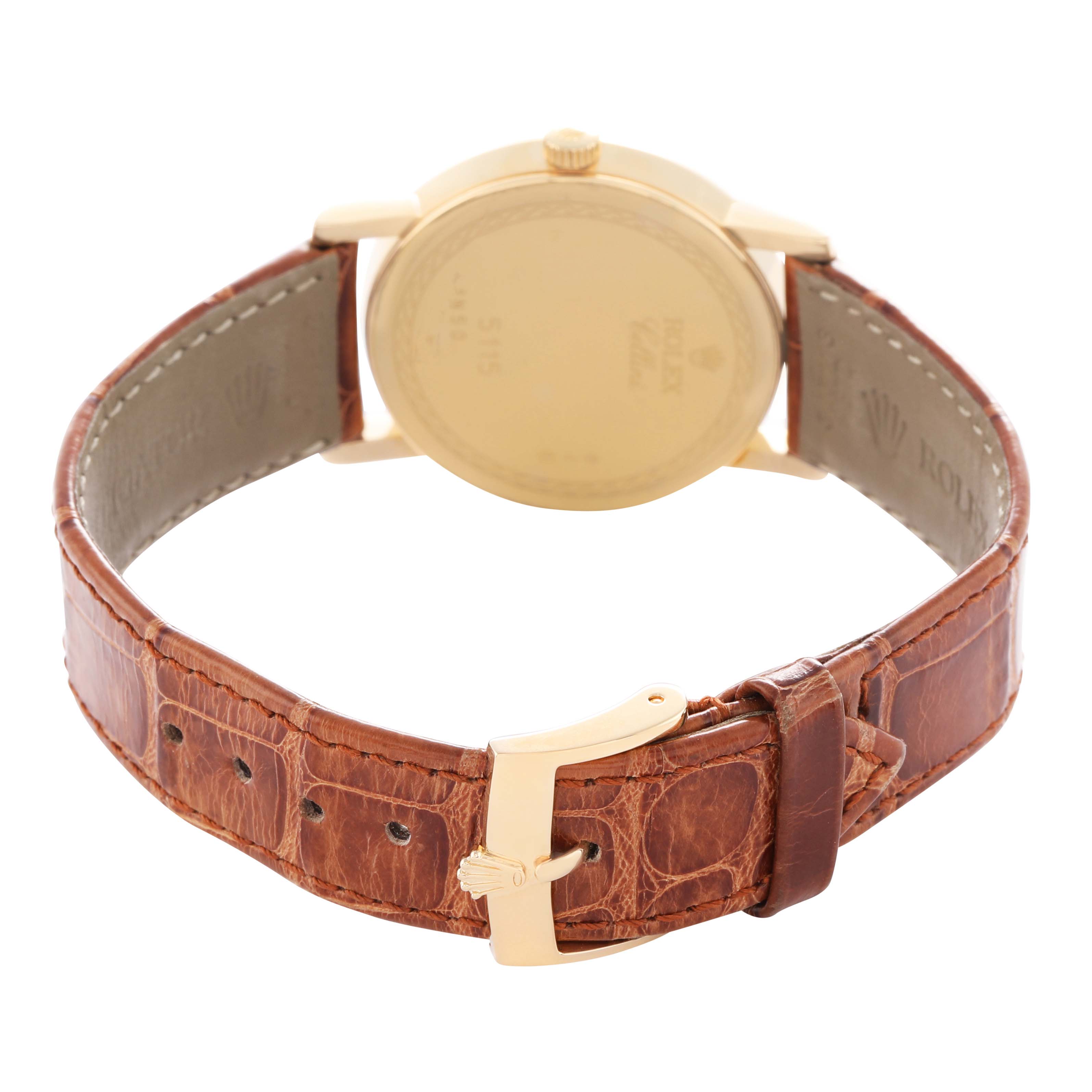 The Rolex Cellini 5115 Men's Yellow Gold Beige Dial watch is shown from the back, highlighting the case, buckle, and leather strap.