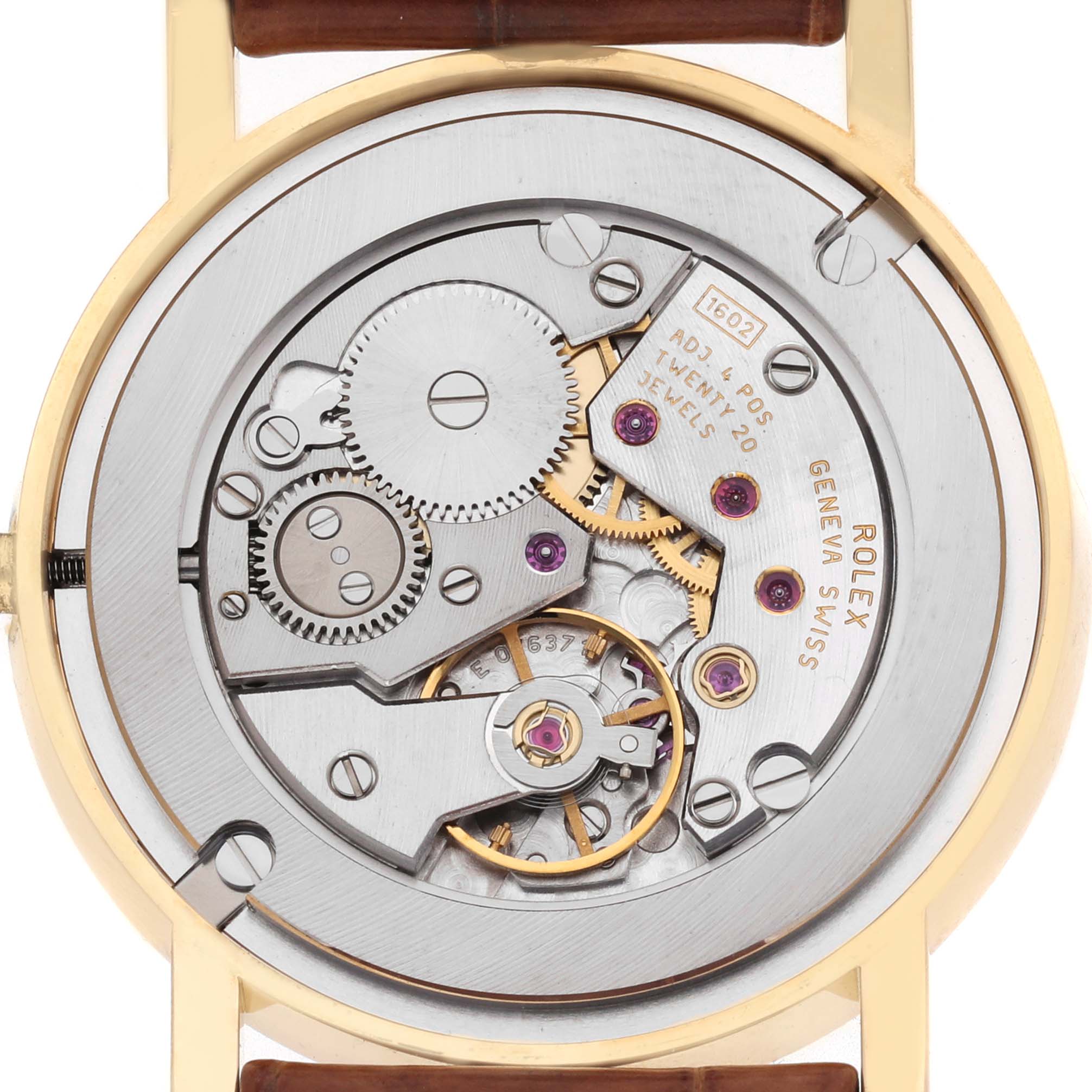 The image shows the rear view of a Rolex Cellini 5115 Men's Yellow Gold Beige Dial watch, highlighting its intricate movement and internal mechanism.