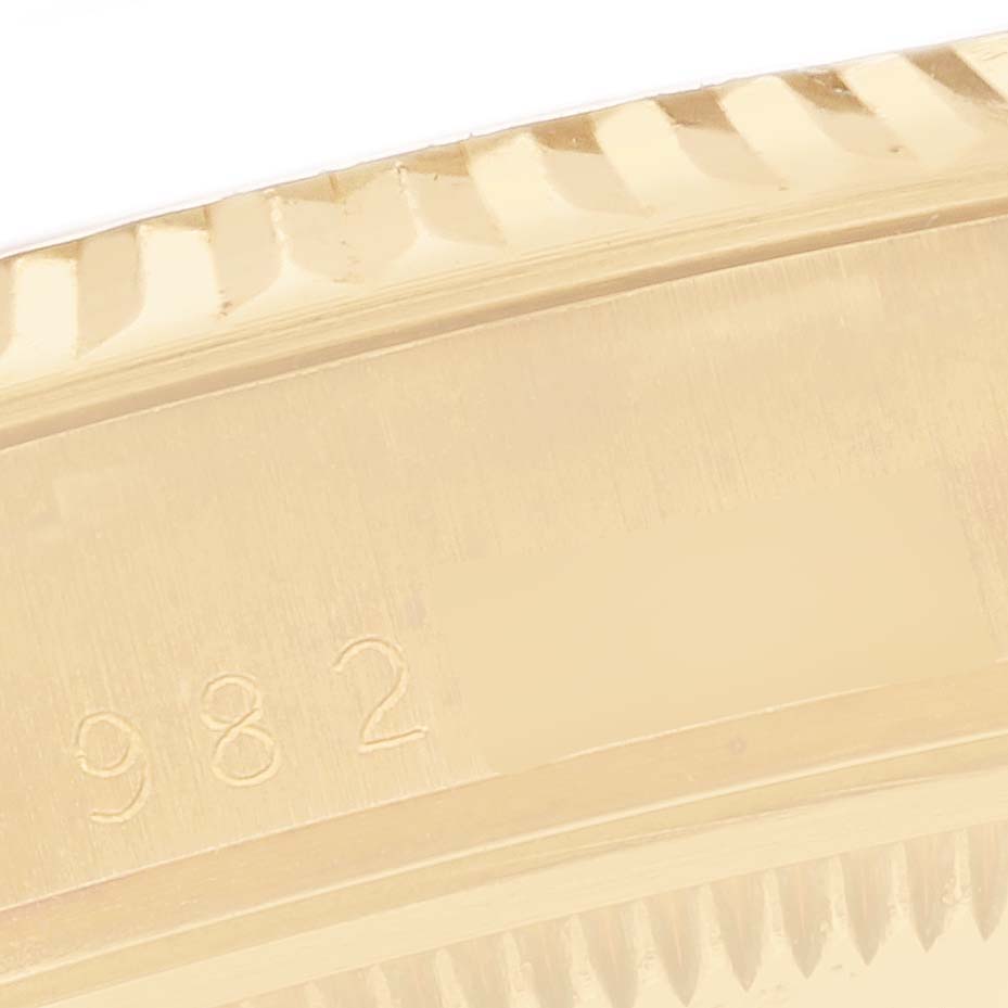 The image shows a close-up of the side of a Rolex Date 15037 Men's Yellow Gold White Dial 15037 Men's Yellow Gold White Dial watch, highlighting the fluted bezel and engraved serial number.