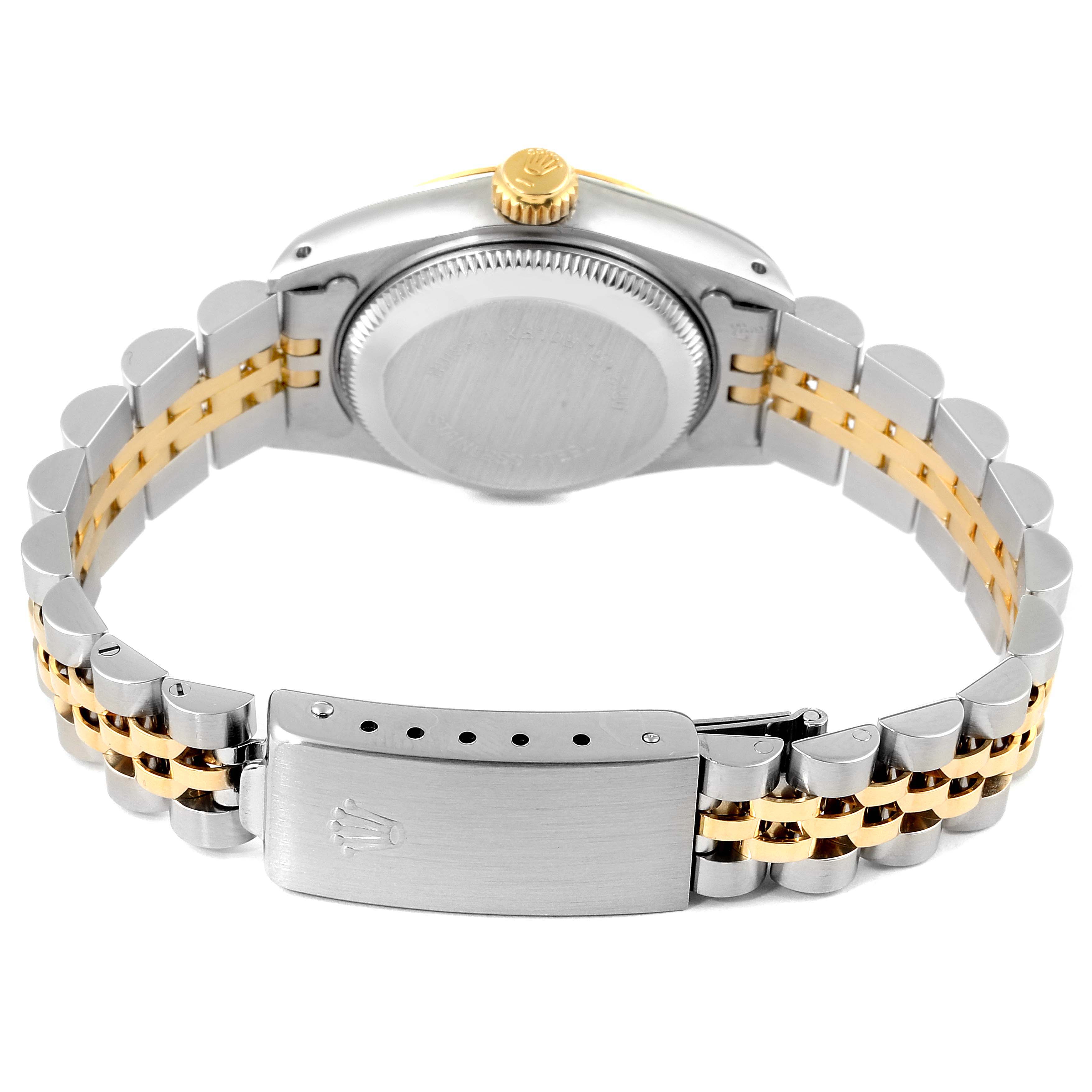 The image shows the back view of a Rolex Datejust 69173 Women
s Steel and Gold (two tone) Champagne Dial 69173 Women
s Steel and Gold (two tone) Champagne Dial watch, highlighting the case, crown, and two-tone bracelet with a clasp.