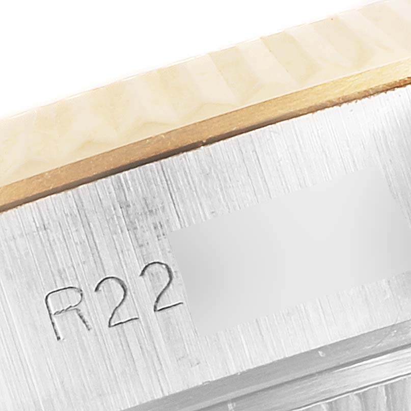 This image shows a close-up of the side of the bezel and case with engraving on a Rolex Datejust 69173 Women
s Steel and Gold (two tone) Champagne Dial 69173 Women
s Steel and Gold (two tone) Champagne Dial watch.