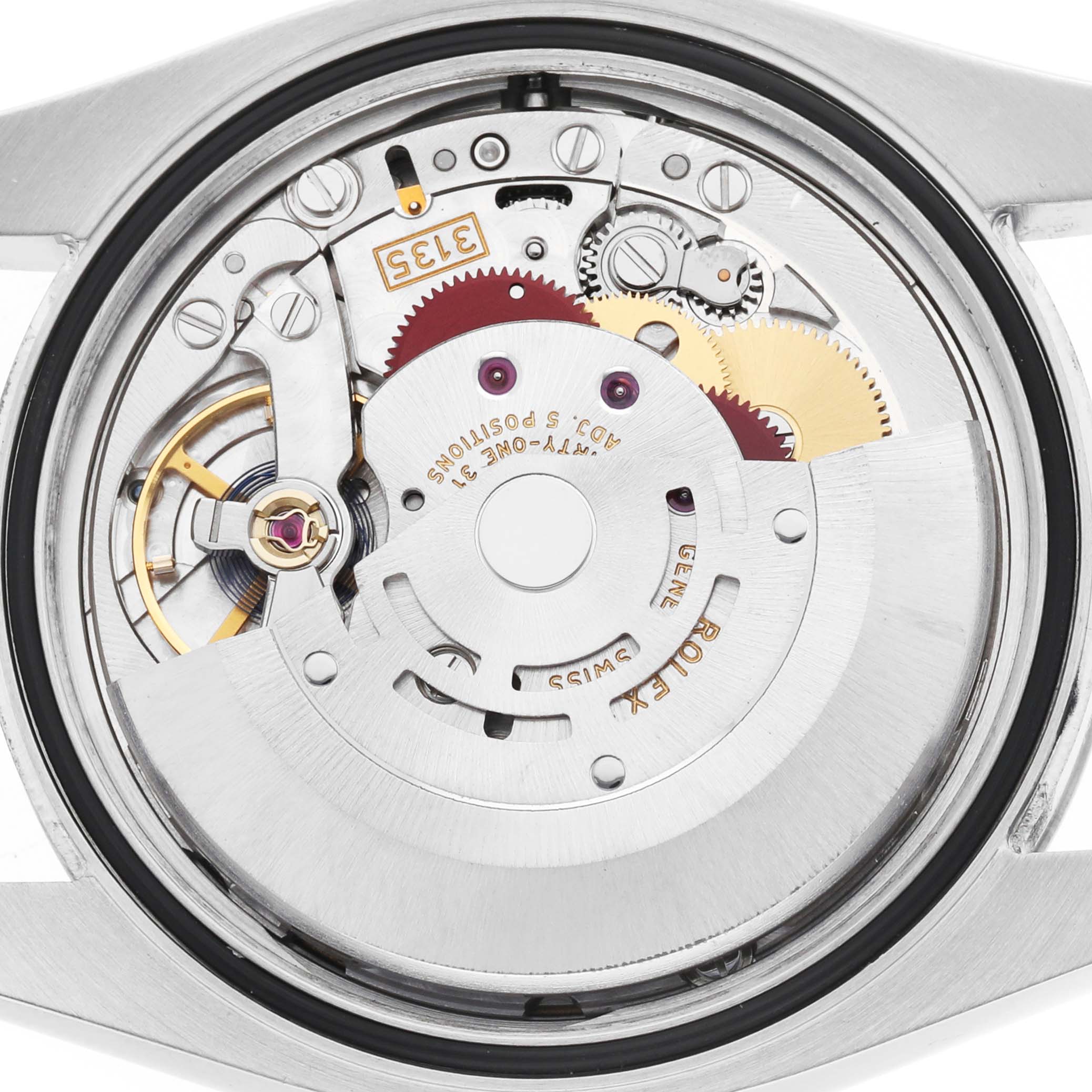 The image shows a close-up view of the movement mechanism of a Rolex Datejust 116200 Men's Stainless Steel Black Dial, highlighting gears and components.