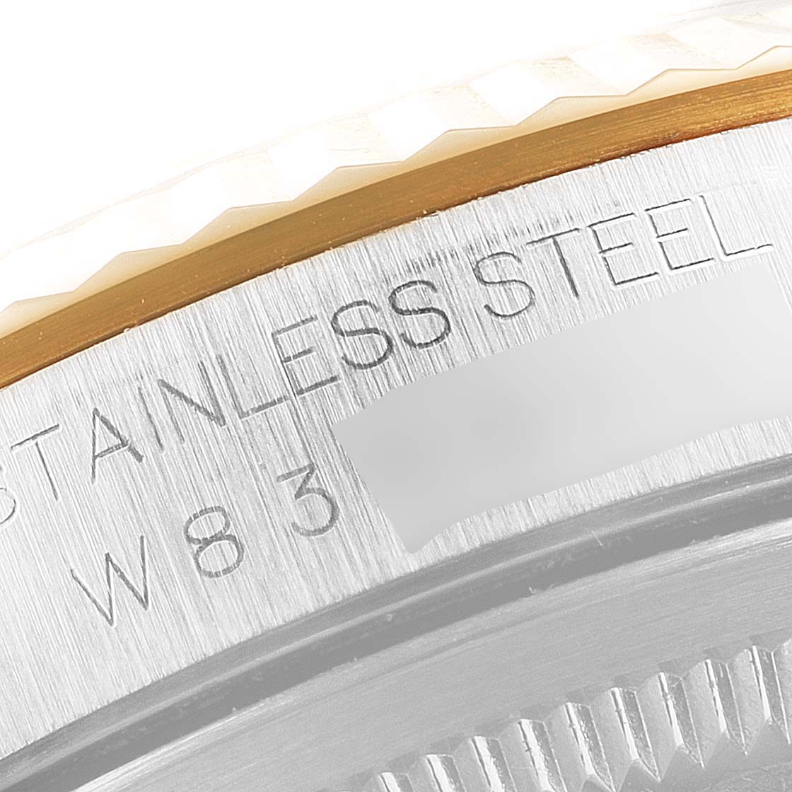 The image shows a close-up of the side view of the bezel and the engraved stainless steel case of a Rolex Datejust 16233 Men's Steel and Gold (two tone) Mother of Pearl Dial 16233 Men's Steel and Gold (two tone) Mother of Pearl Dial watch.