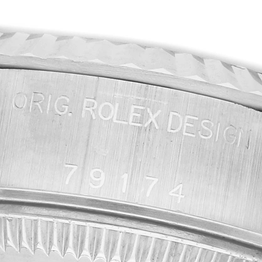 The image shows the side engraving and textured bezel of a Rolex Datejust 79174 Women's Stainless Steel Mother of Pearl Dial watch.