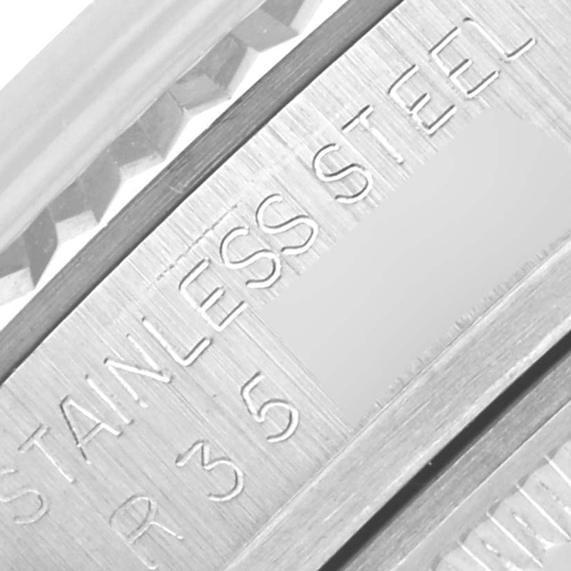 The image shows a close-up of the Rolex Datejust 16014 Men's Stainless Steel Silver Dial 16014 Men's Stainless Steel Silver Dial's stainless steel case with part of the bezel visible.