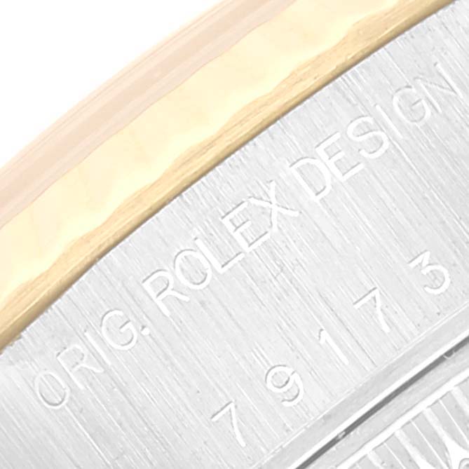 This image shows a close-up of the casing and outer rim of the Rolex Datejust 79173 Women's Steel and Gold (two tone) Champagne Dial 79173 Women's Steel and Gold (two tone) Champagne Dial, highlighting the engraved text "ORIG. ROLEX DESIGN".