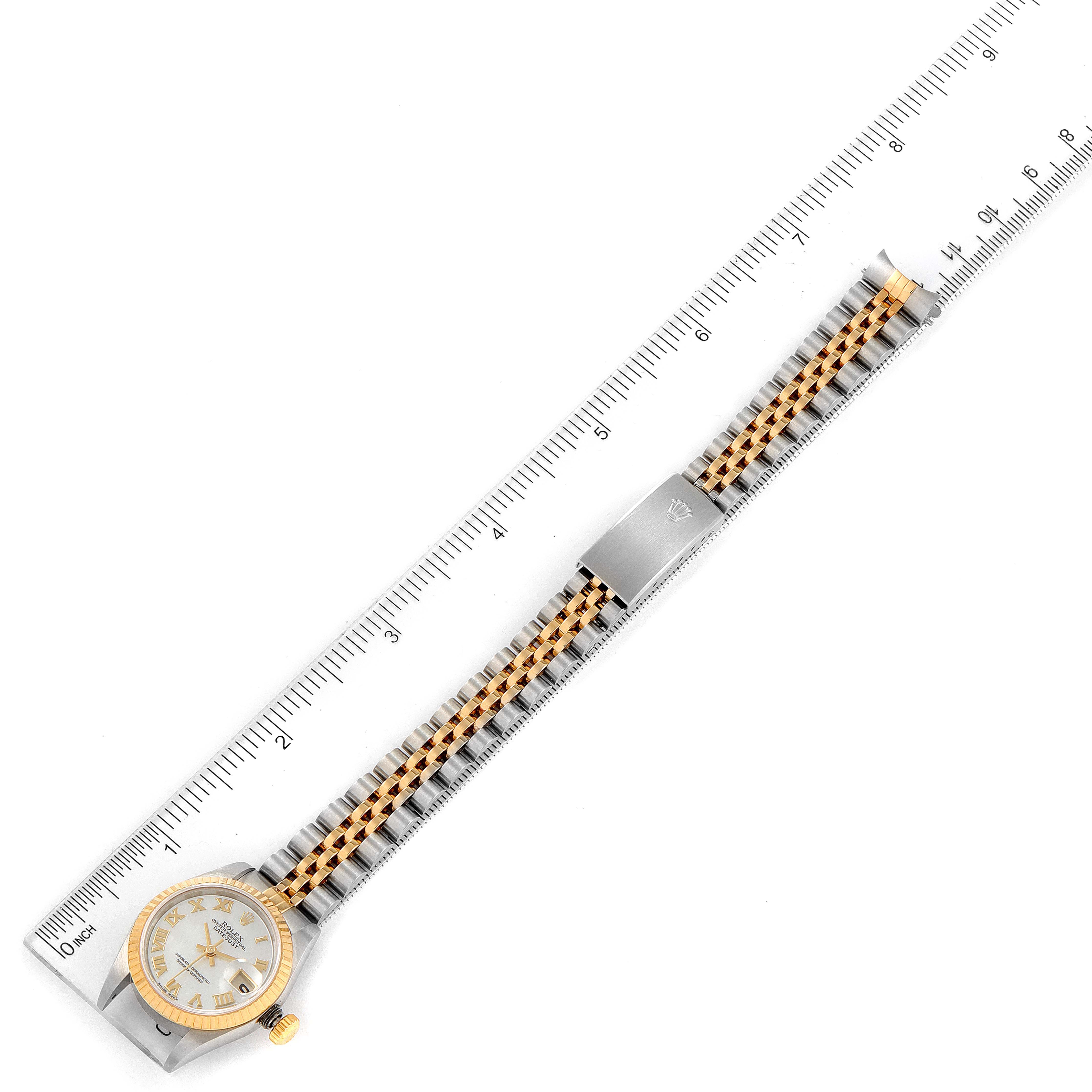 This Rolex Datejust 69173 Women's Steel and Gold (two tone) Mother of Pearl Dial 69173 Women's Steel and Gold (two tone) Mother of Pearl Dial watch is displayed fully extended with its face, bezel, bracelet, and clasp visible alongside a ruler for size reference.