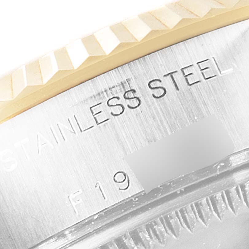 This image shows a close-up of the bezel and the engraved "STAINLESS STEEL" text on a Rolex Datejust 69173 Women's Steel and Gold (two tone) Mother of Pearl Dial 69173 Women's Steel and Gold (two tone) Mother of Pearl Dial watch.