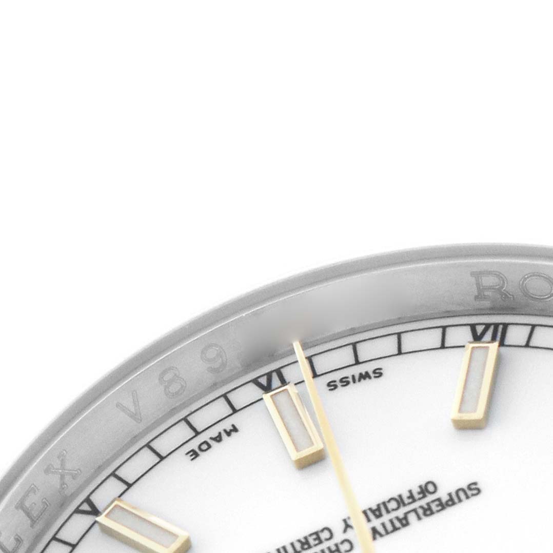 The image shows a close-up of the Rolex Datejust 116233 Men's Steel and Gold (two tone) White Dial's dial, bezel, and markers from an angled perspective.