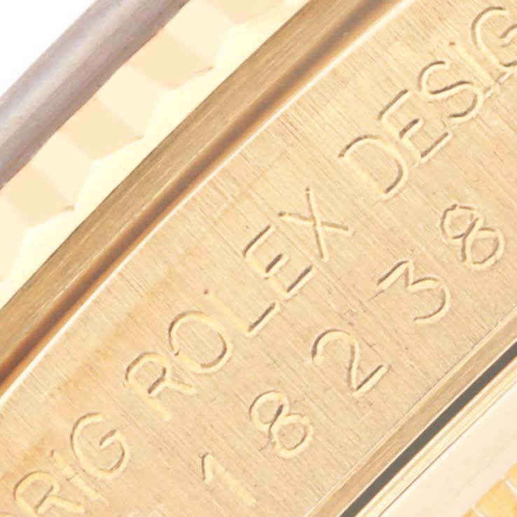 The image shows a close-up of the engraved inner bezel of a Rolex President 18238 Men
s Yellow Gold Champagne Dial 18238 Men
s Yellow Gold Champagne Dial model watch.