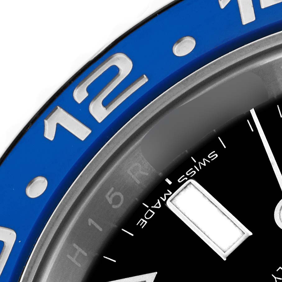 The image shows a close-up of the Rolex GMT-Master 116710BLNR Men
s Stainless Steel Black Dial 116710BLNR Men
s Stainless Steel Black Dial
s bezel and part of the dial, focusing on the "12" marker and "Swiss Made" text.