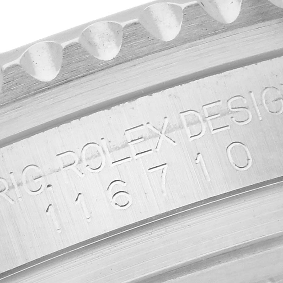 The image shows a close-up of the Rolex GMT-Master 116710BLNR Men
s Stainless Steel Black Dial 116710BLNR Men
s Stainless Steel Black Dial model’s engraved bezel and case details.