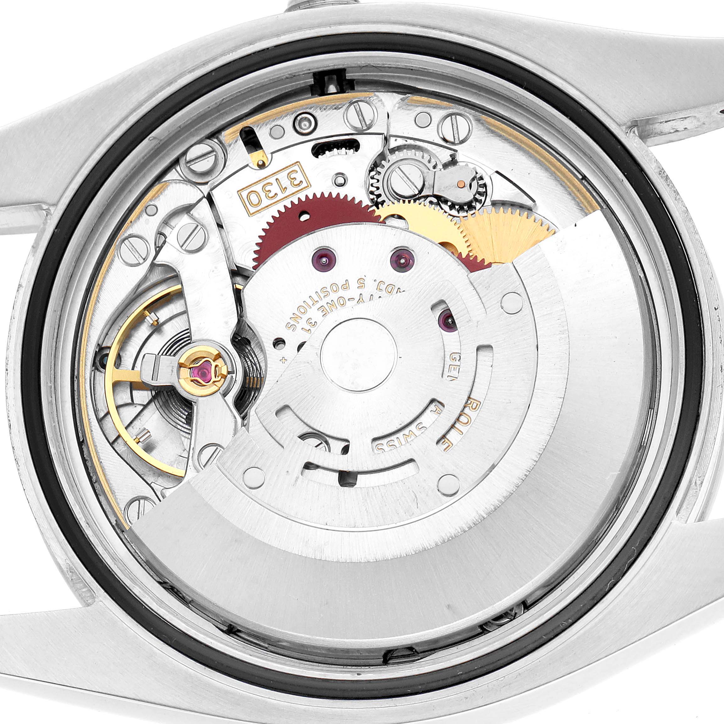 The image shows the back view of a Rolex Oyster Perpetual 116000 Men's Stainless Steel Silver Dial, revealing the watch movement and internal mechanisms.