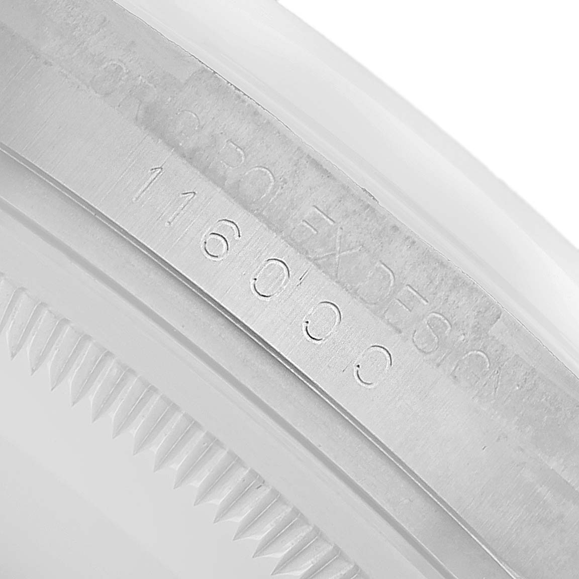 The image shows an angled close-up of the inner bezel of a Rolex Oyster Perpetual 116000 Men's Stainless Steel Silver Dial watch with the model number 116000.