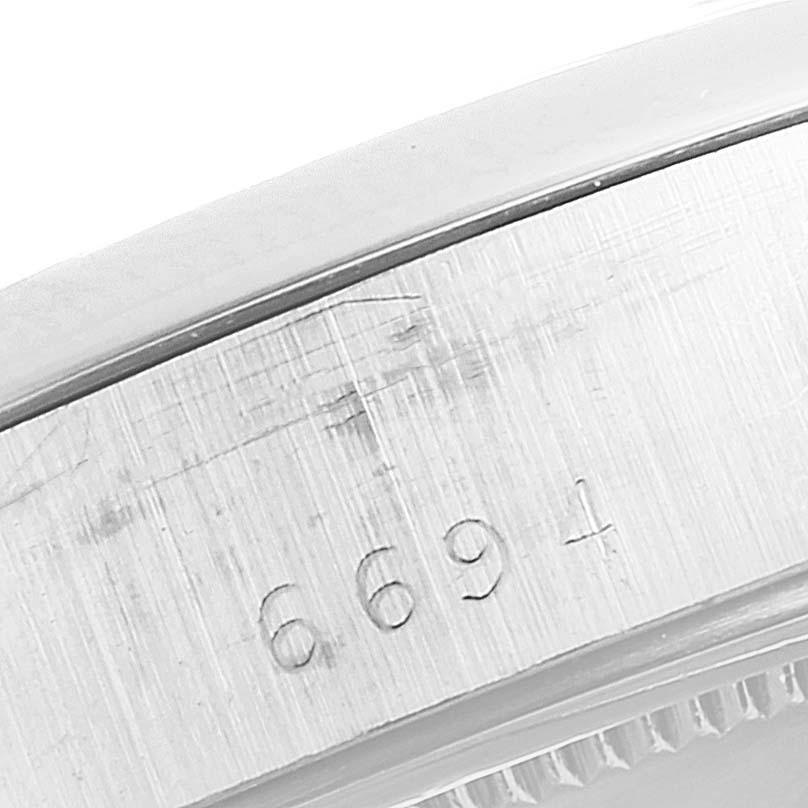The image shows a close-up of the engraved model number on the side of the Rolex Vintage Collection 6694 Men
s Stainless Steel Silver Dial 6694 Men
s Stainless Steel Silver Dial watch case.
