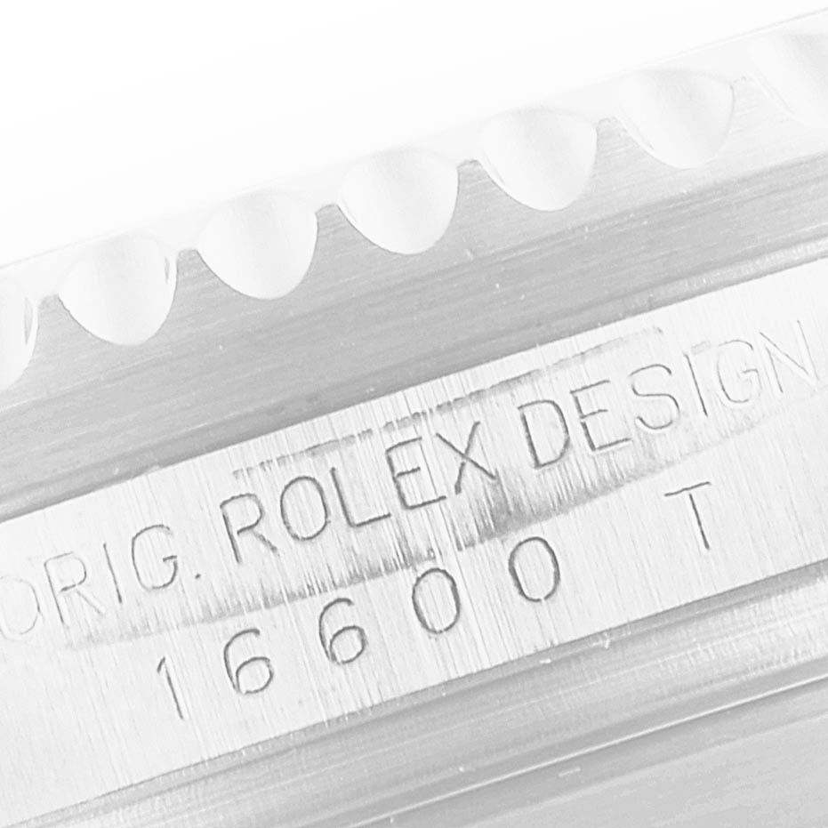 This close-up image shows the engraved model number and branding on the side of a Rolex Sea-Dweller 16600 Men
s Stainless Steel Black Dial 16600 Men
s Stainless Steel Black Dial watch case, displaying "ORIG. ROLEX DESIGN 16600 T."