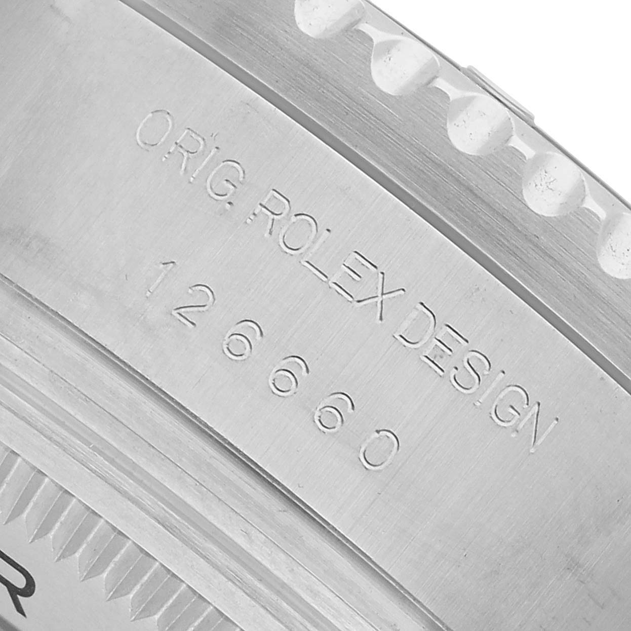 This image shows a close-up of the case side of the Rolex Sea-Dweller 126660 Men's Stainless Steel Blue Dial, featuring its model number and "Orig Rolex Design" engraving.