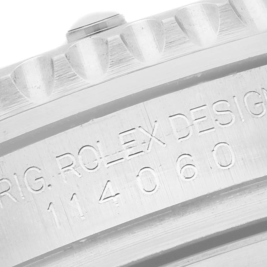 The image shows a close-up of the Rolex Submariner 114060LN Men's Stainless Steel Black Dial 114060LN Men's Stainless Steel Black Dial's bezel and engraved case side.