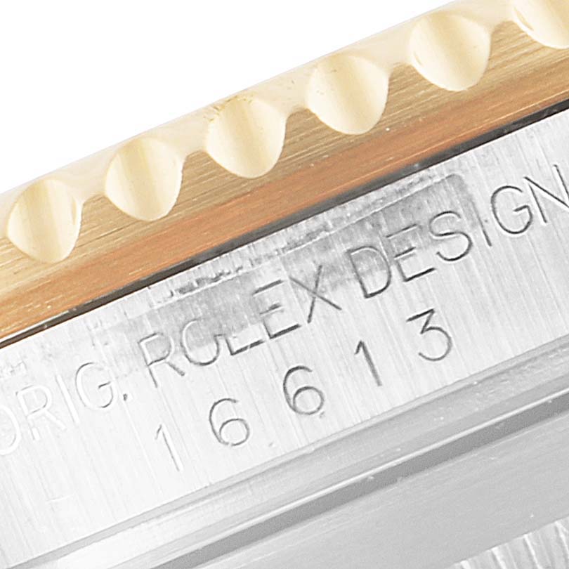 This is a close-up image of the side of the Rolex Submariner 16613 Men's Steel and Gold (two tone) Blue Dial 16613 Men's Steel and Gold (two tone) Blue Dial, showing the bezel edge and the engraved model number "16613".