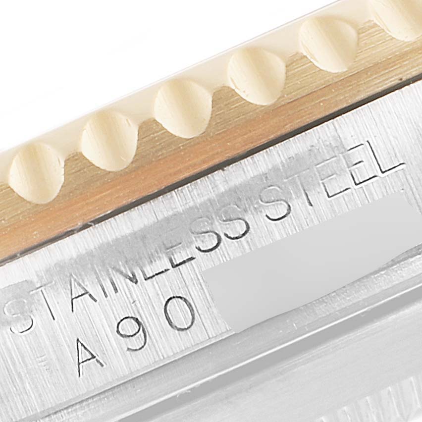 This image shows a close-up of the bezel, teeth, and stainless steel casing of a Rolex Submariner 16613 Men's Steel and Gold (two tone) Blue Dial 16613 Men's Steel and Gold (two tone) Blue Dial watch.