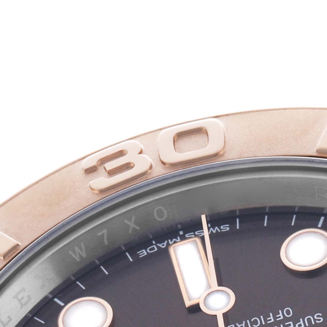 The image shows a close-up of the Rolex Yacht-Master 116621 Men's Steel and Gold (two tone) Brown Dial watch, highlighting the bezel and part of the dial.