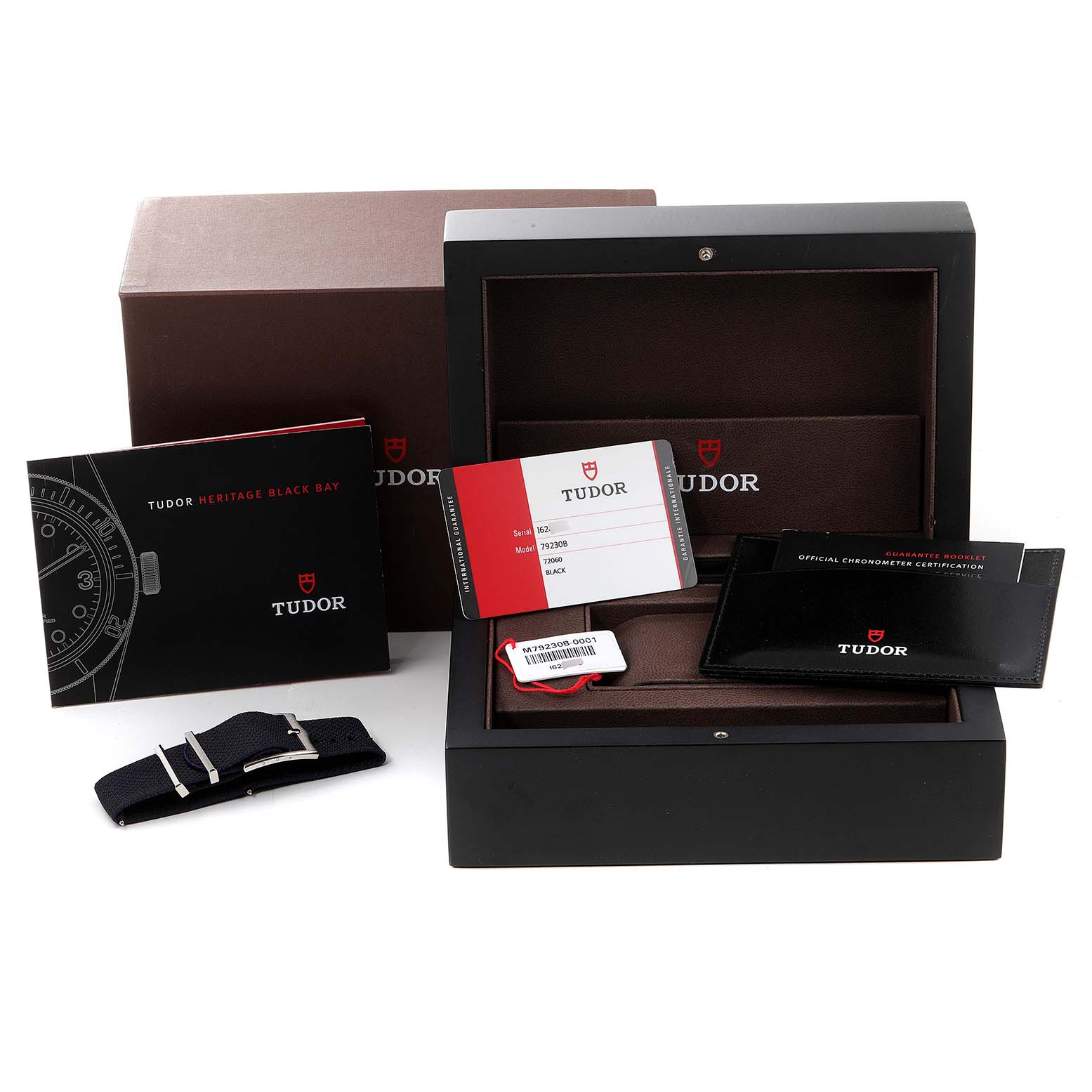 The image shows Tudor Heritage Black Bay 79230B Men's Stainless Steel Black Dial 79230B Men's Stainless Steel Black Dial packaging, including a box, manuals, warranty card, and a NATO strap.