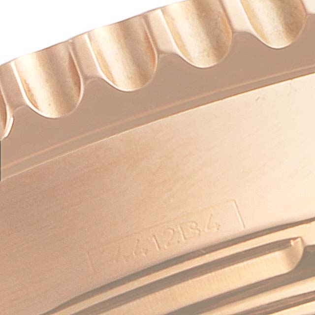 The image shows a close-up of the Breitling Navitimer RB0120 Men's Rose Gold Black Dial RB0120 Men's Rose Gold Black Dial watch bezel, highlighting its ridged edges and part of the case back.