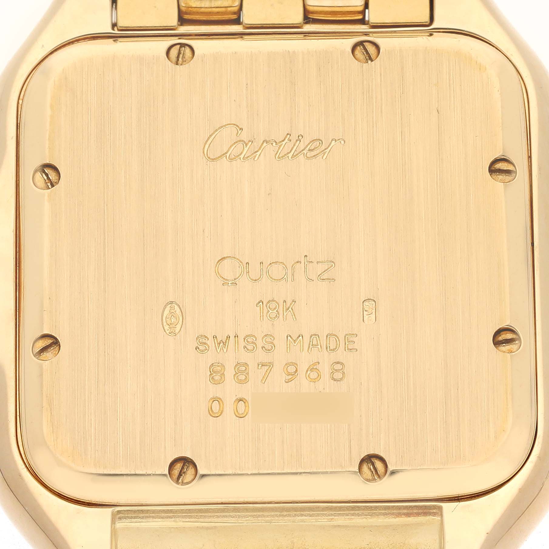 The image shows the back case of a Cartier Panthere W25014B9 Men's Yellow Gold Silver Dial W25014B9 Men's Yellow Gold Silver Dial watch, highlighting its engravings and screws.